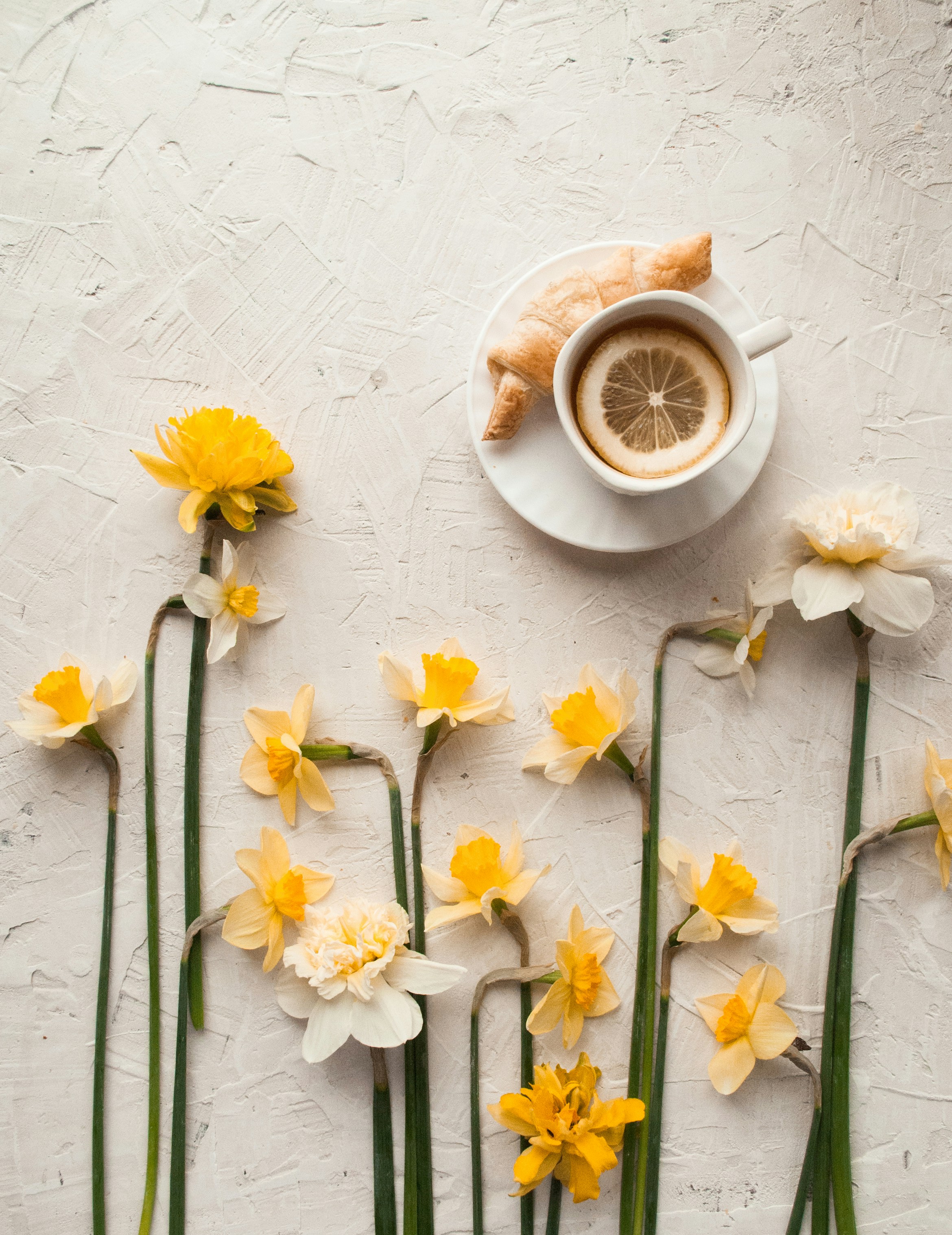 Flat Lay with Daffodils and Lemon Tea