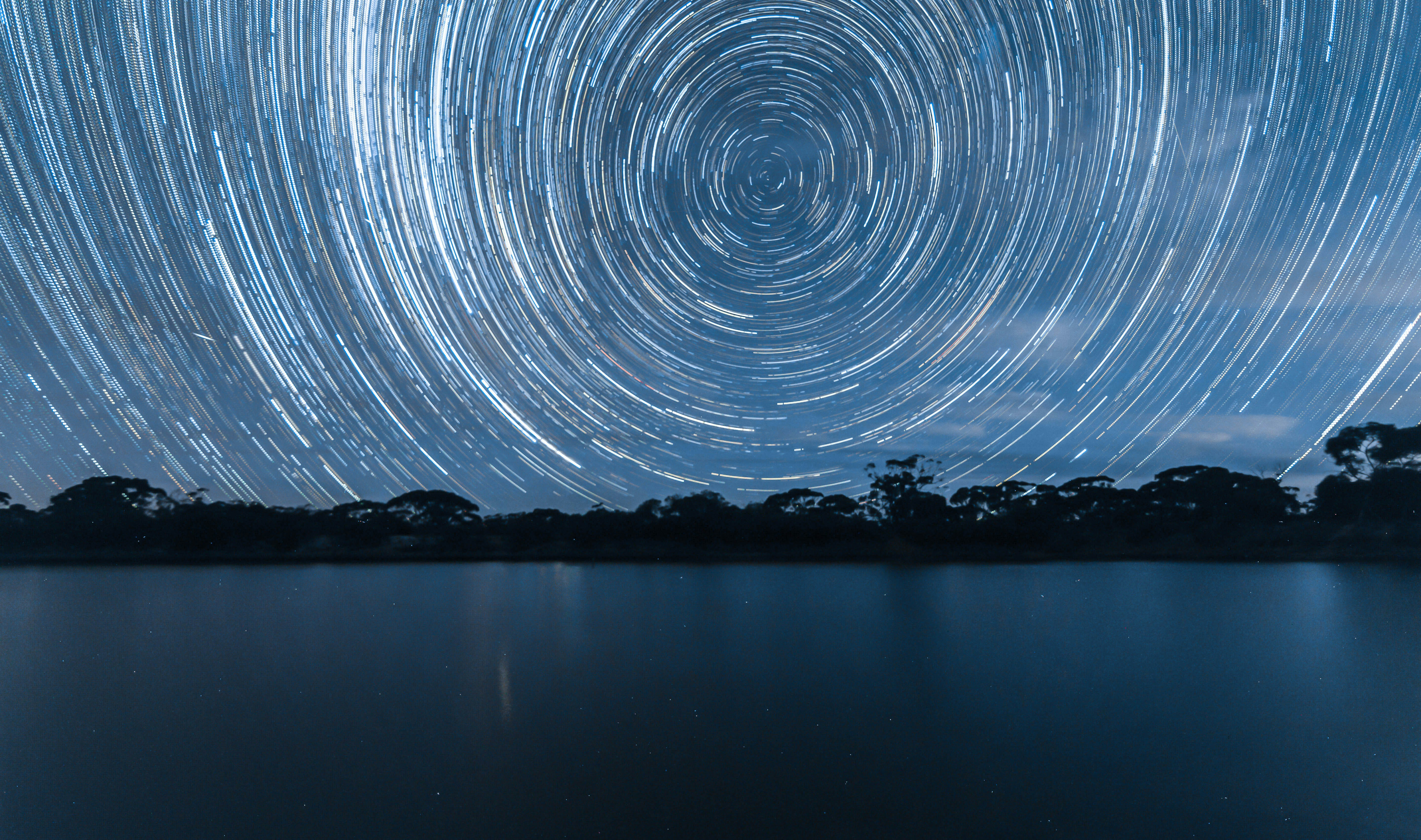 Star Trails Over Calm Lake