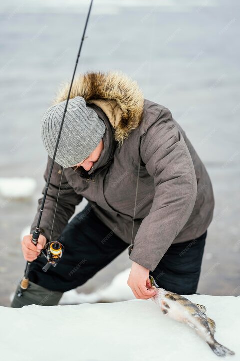 Man Ice Fishing With Fresh Catch
