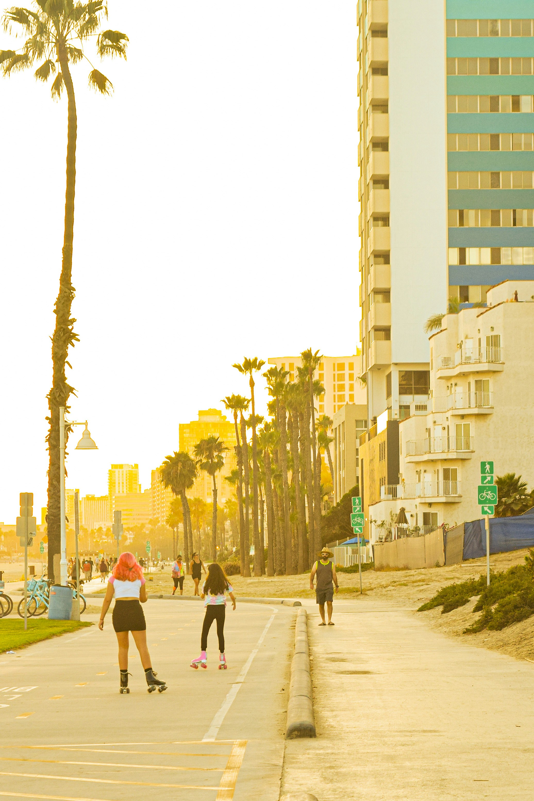 Two Girls Rollerskating on Coastal Path