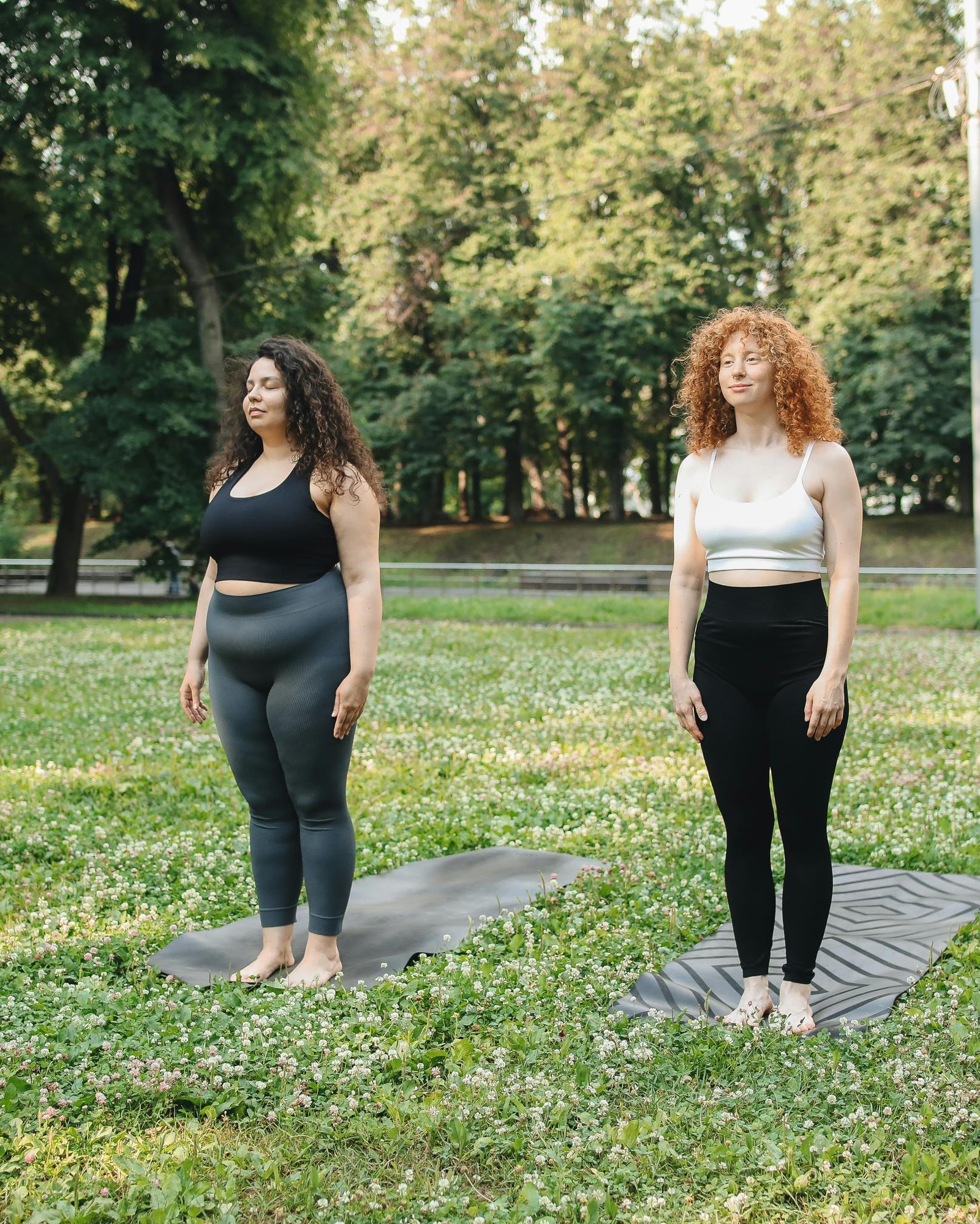 Two Women Practicing Yoga in Park
