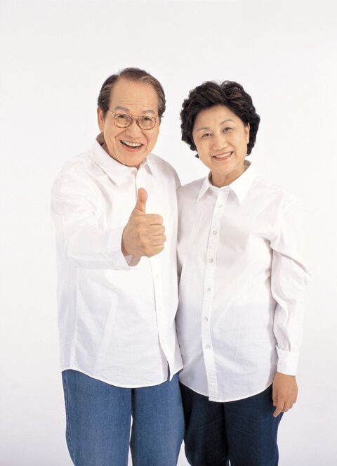 Cheerful Senior Couple With Thumbs Up