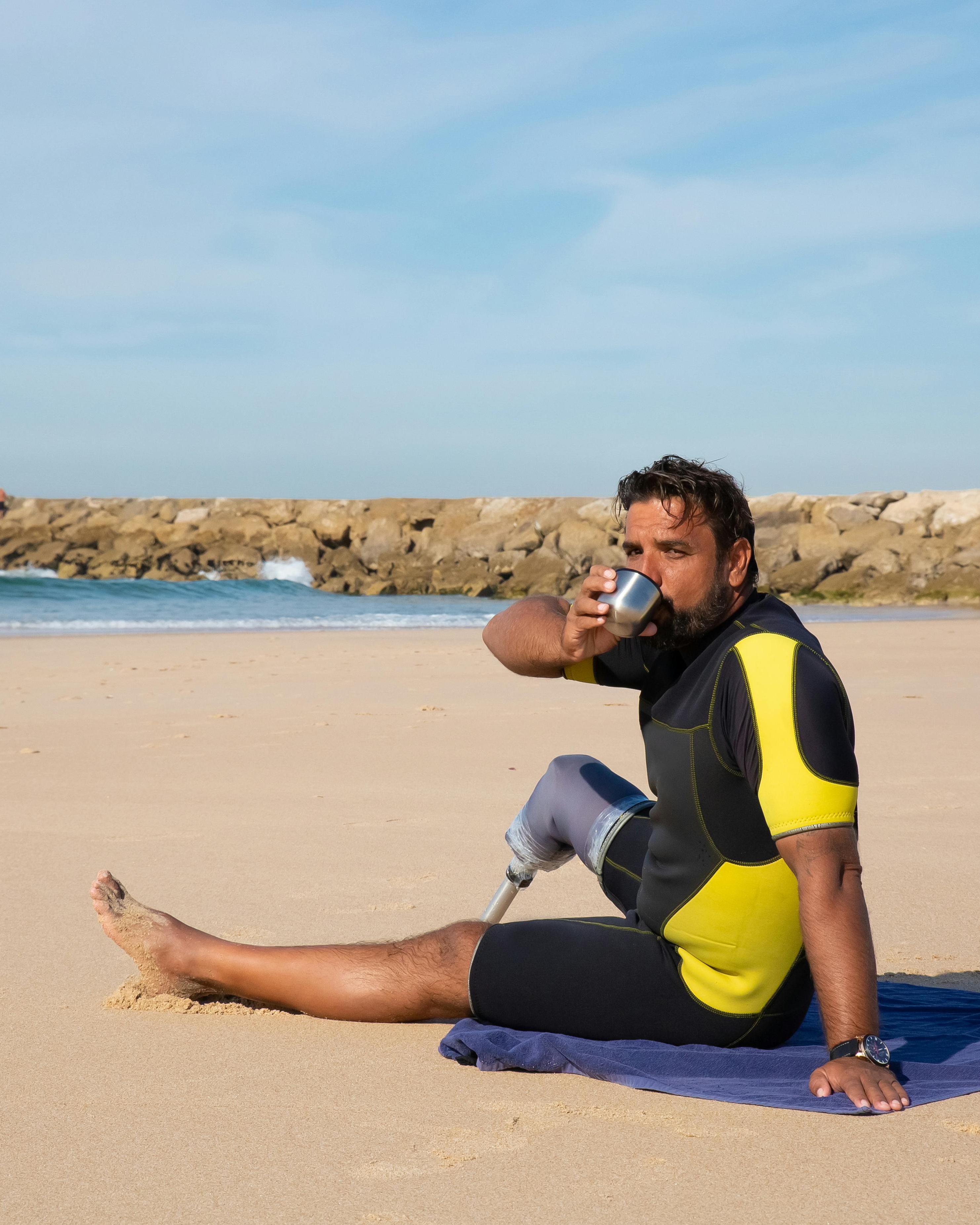 Man With Prosthetic Leg Relaxing on Beach
