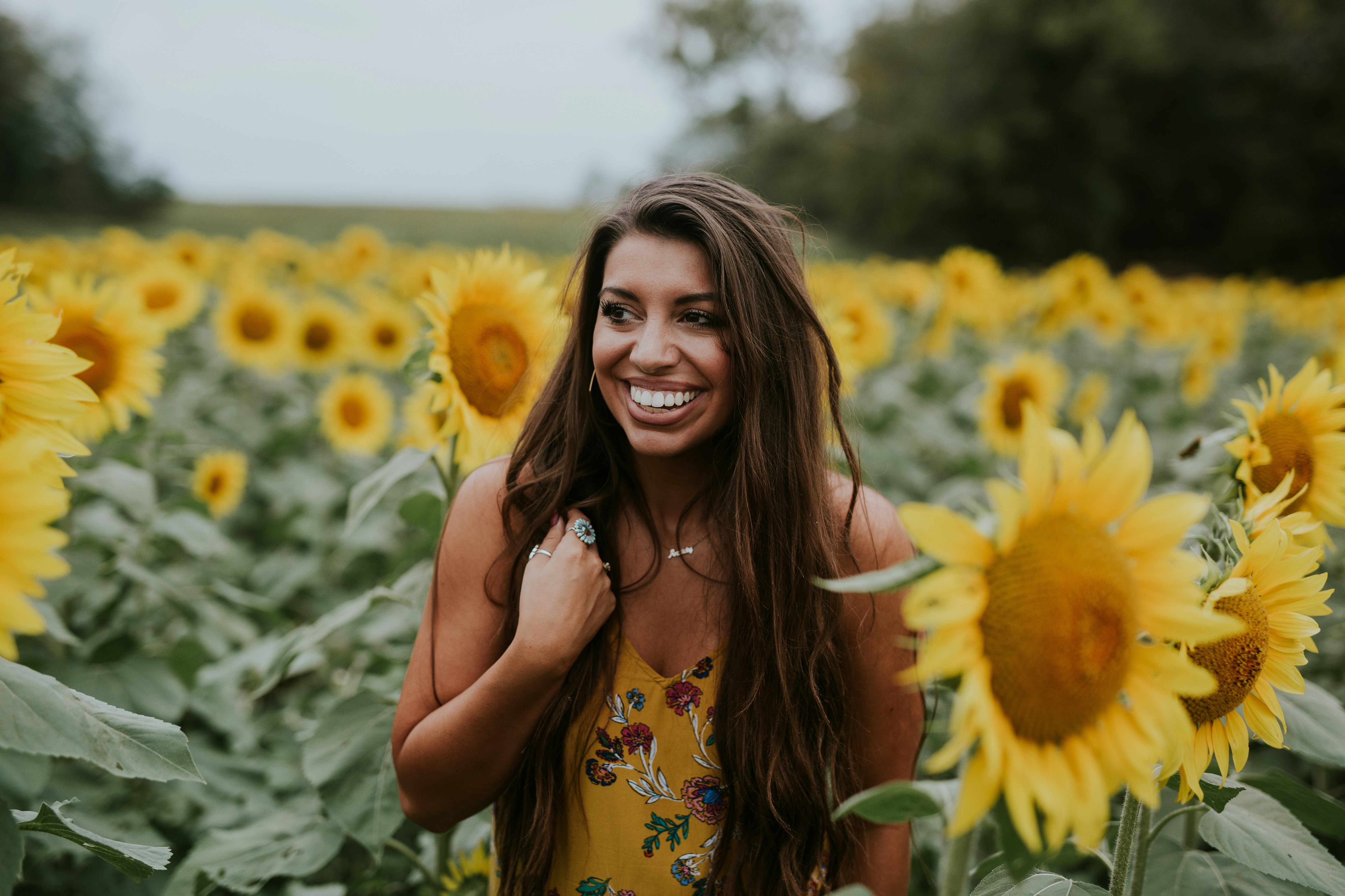 Smiling Woman in Sunflower Field