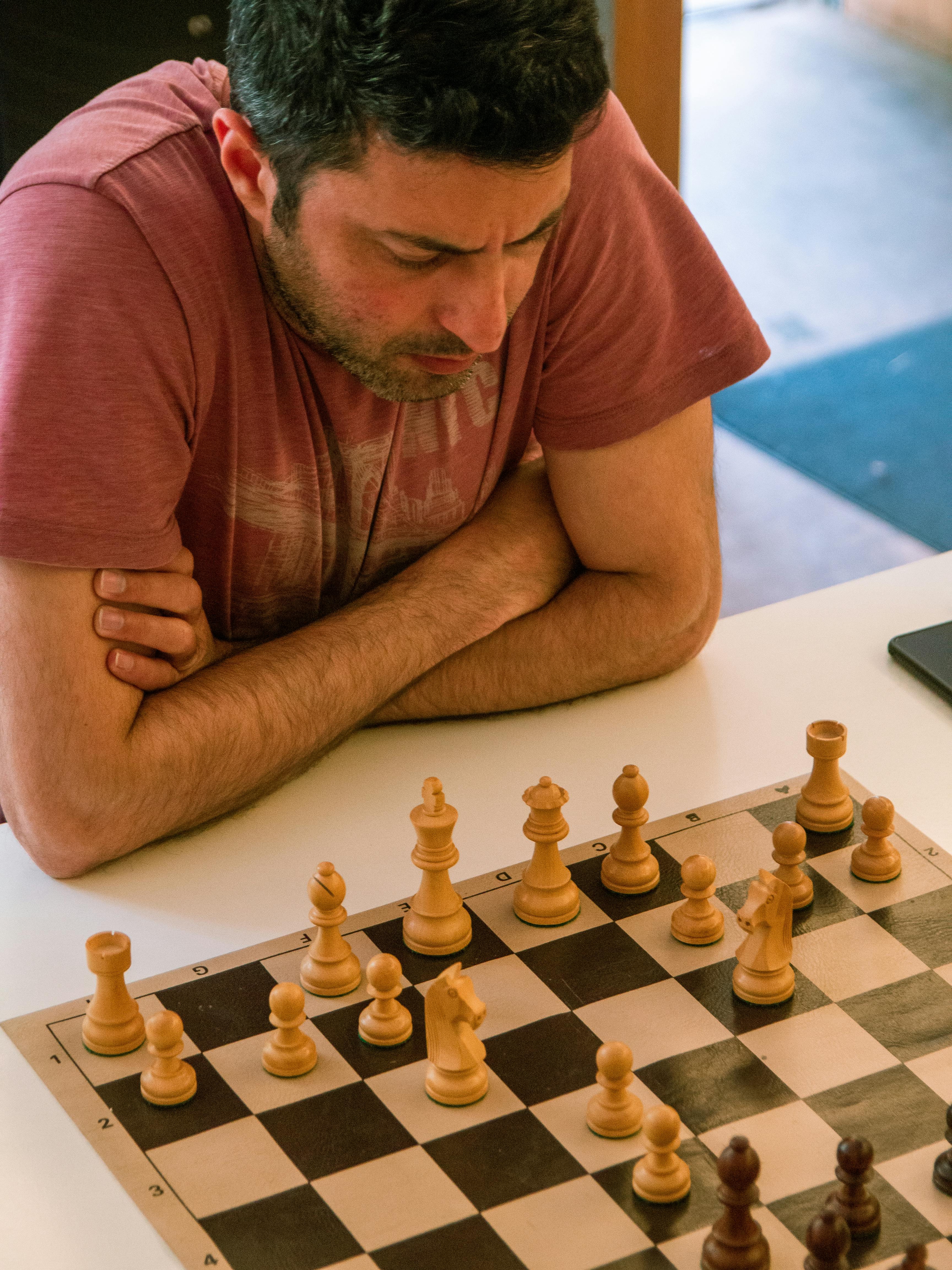 Man Concentrating On Chess Game