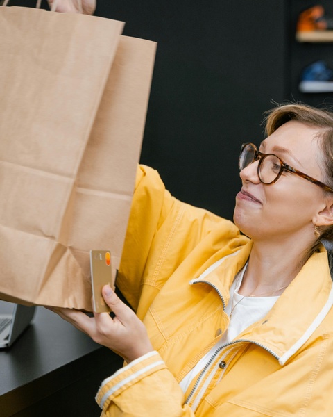 Woman Holding Shopping Bags and Credit Card