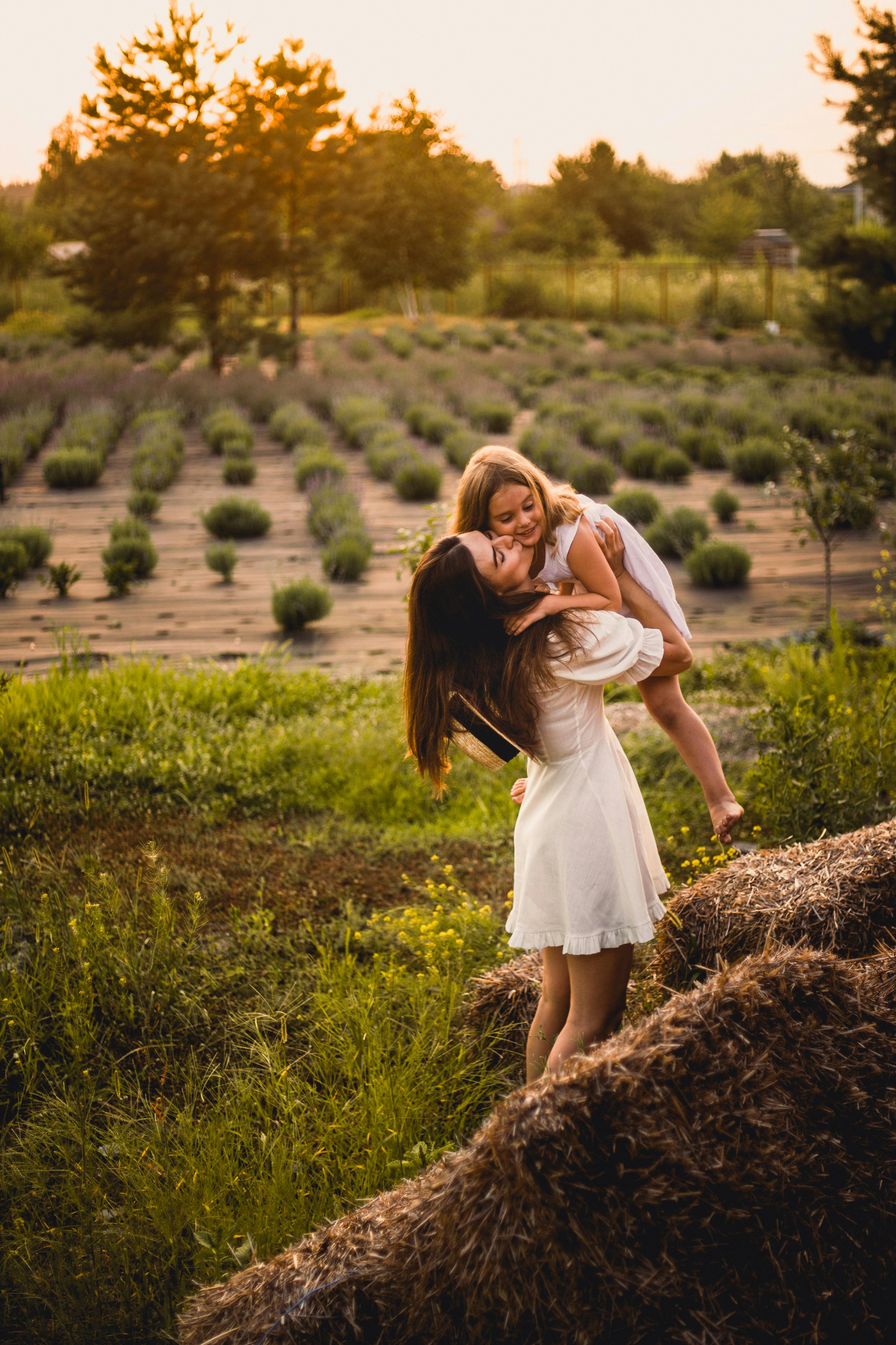 Mother and Daughter Hugging in Lavender Field