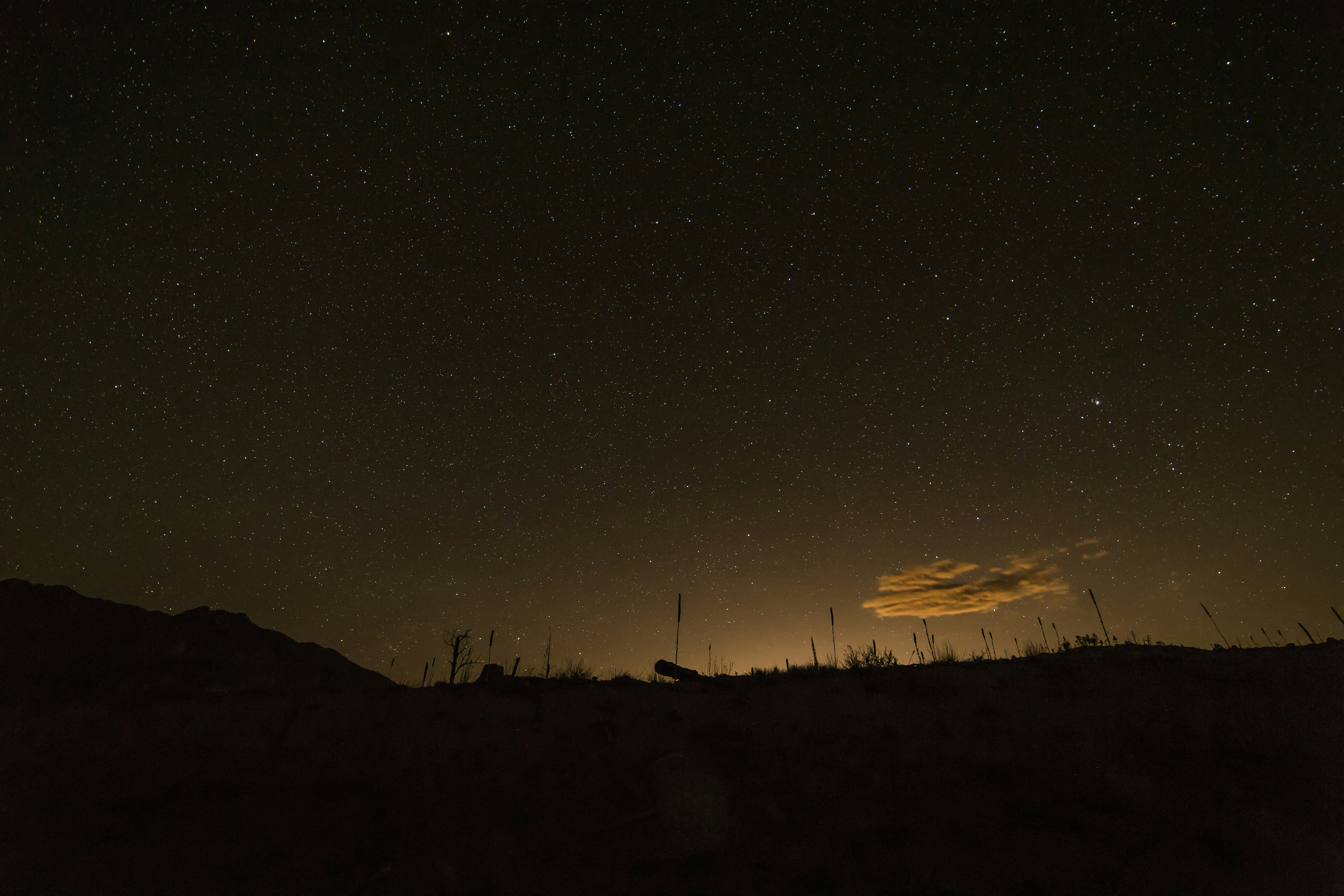Starry Night Sky Over Hill Silhouette
