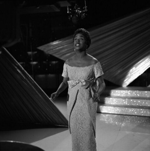 Black Female Singer Performing on Stage