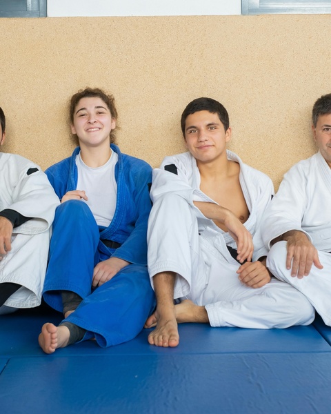 Martial Arts Trainees Resting After Class