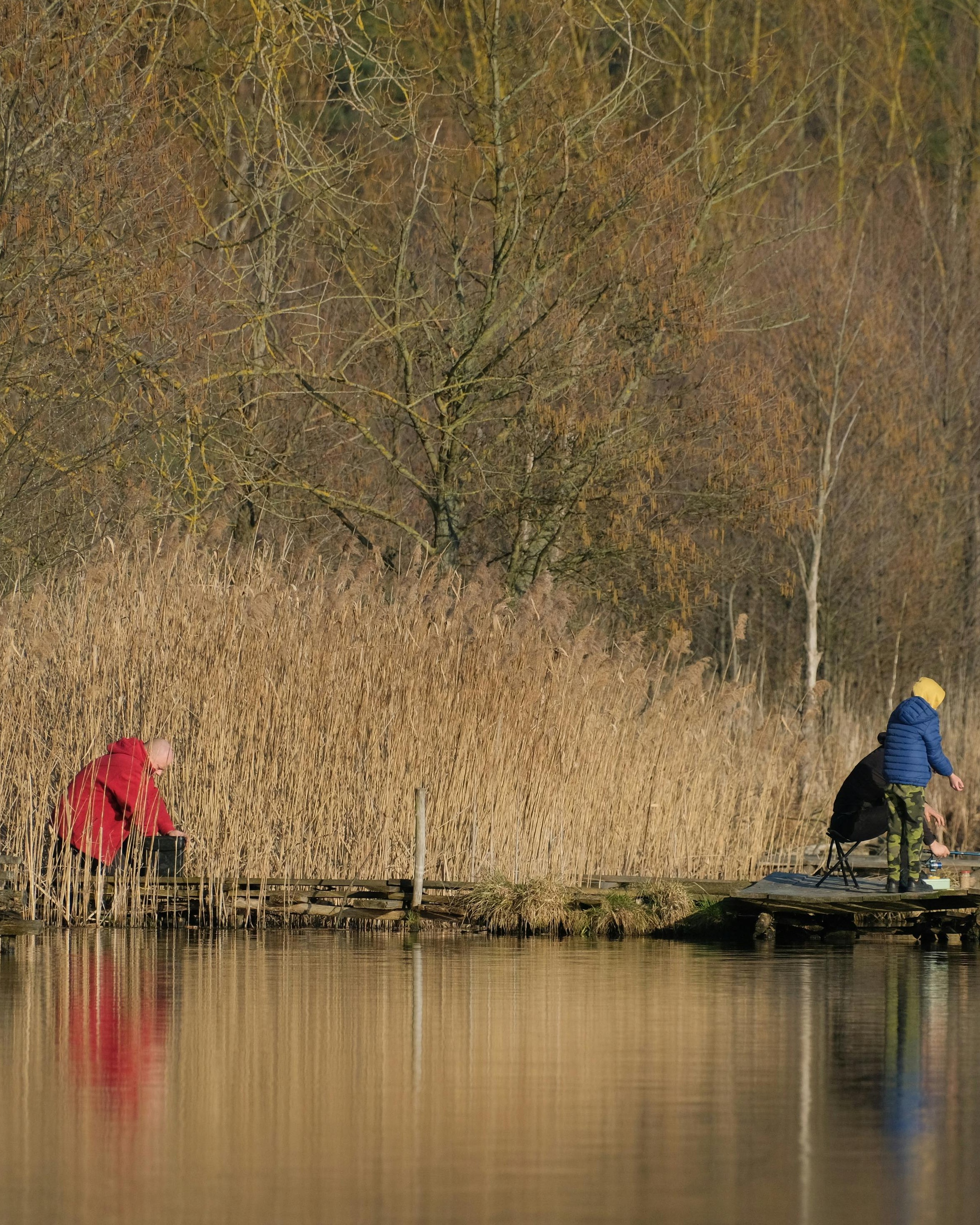 Three Anglers Fishing on Lake Dock