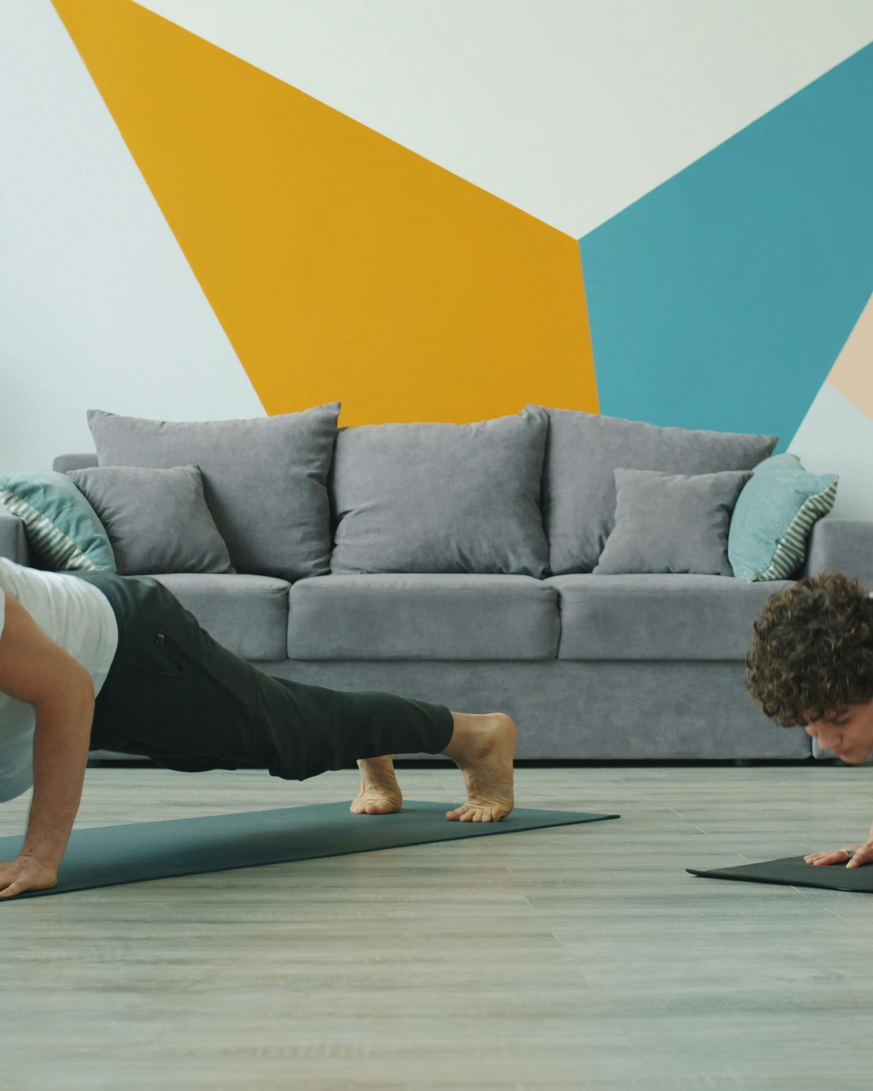 Two People Doing Plank Exercise At Home