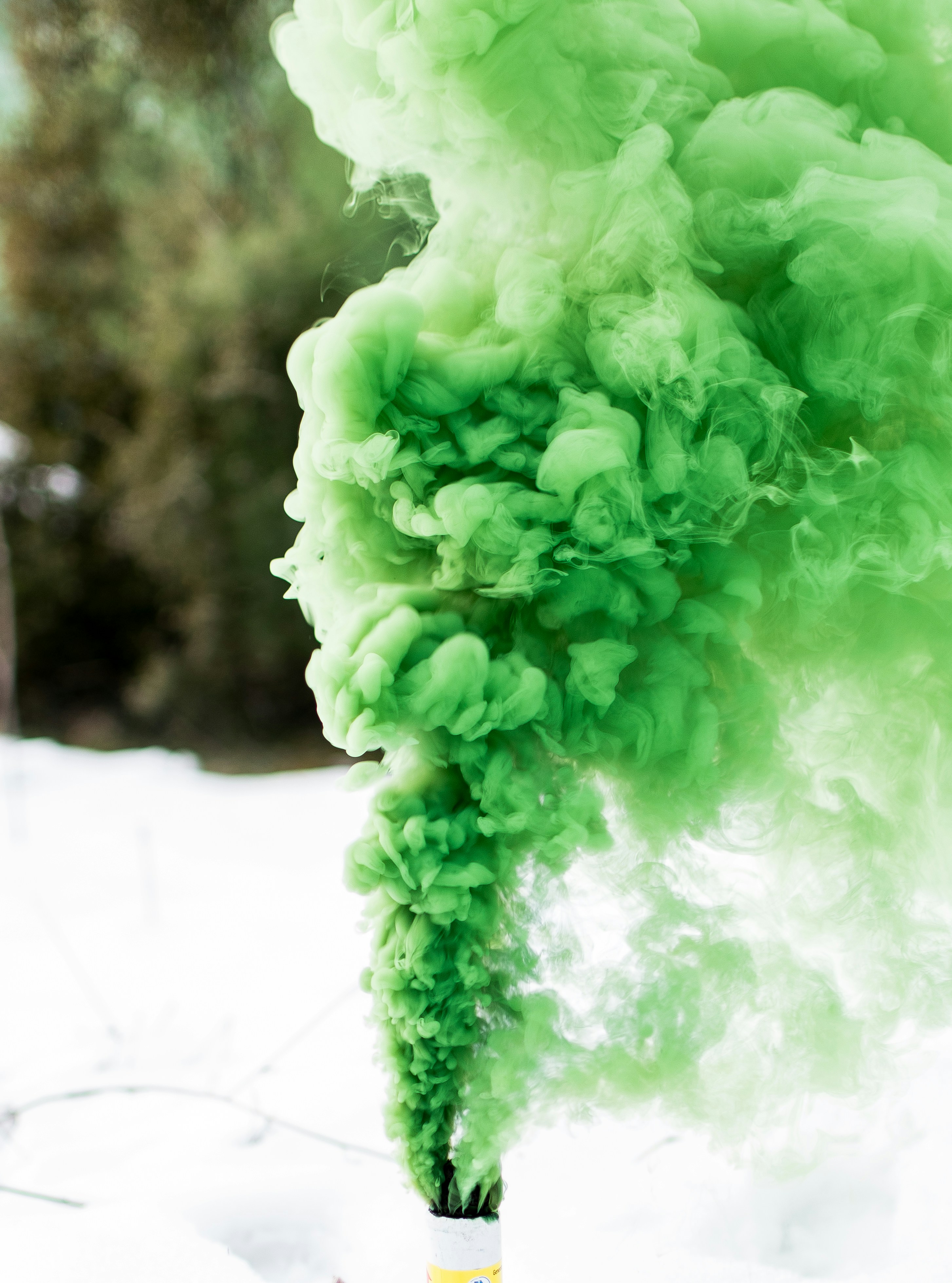Green Smoke Flare on Snowy Ground