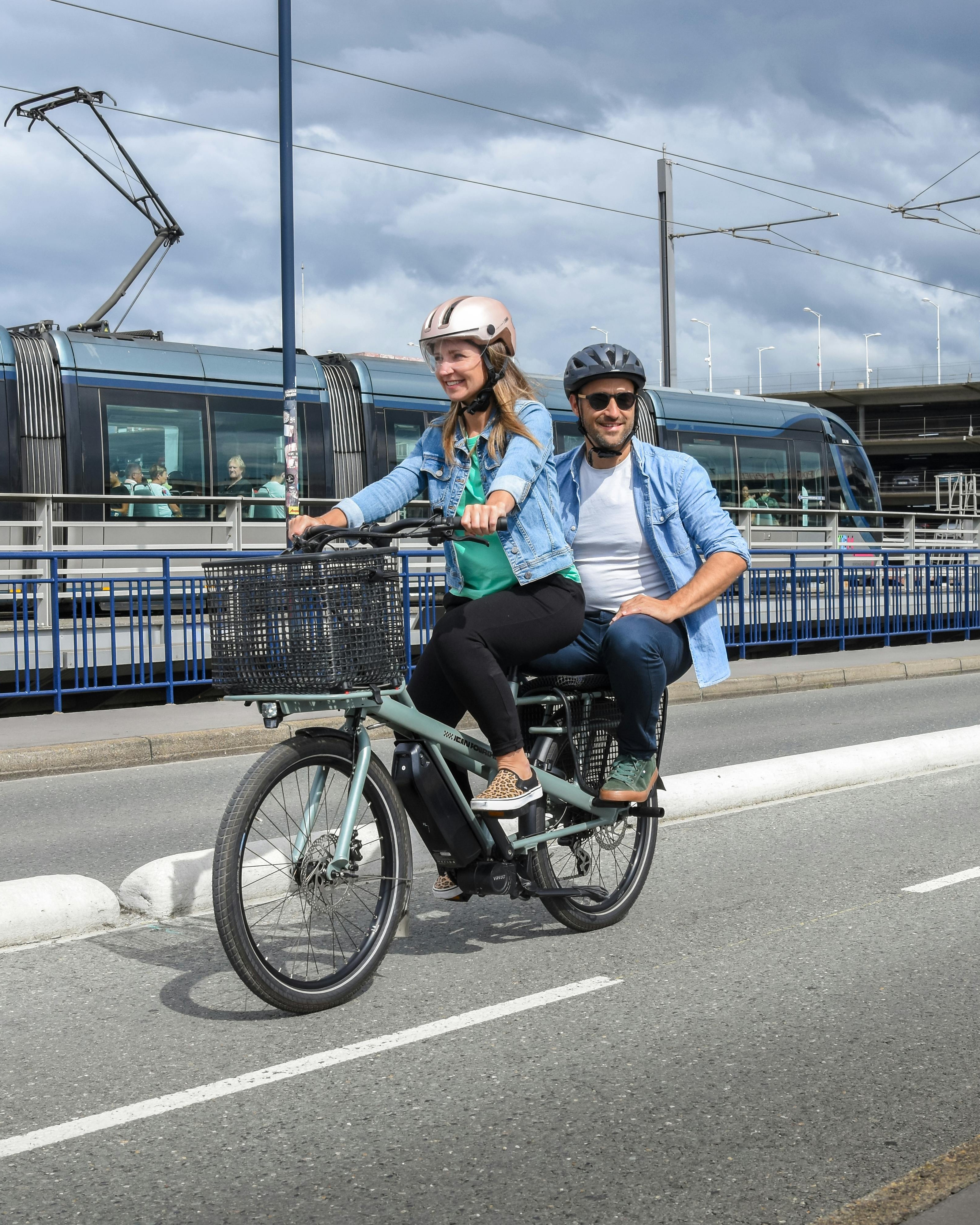 Two People Riding Dual Seat Bicycle