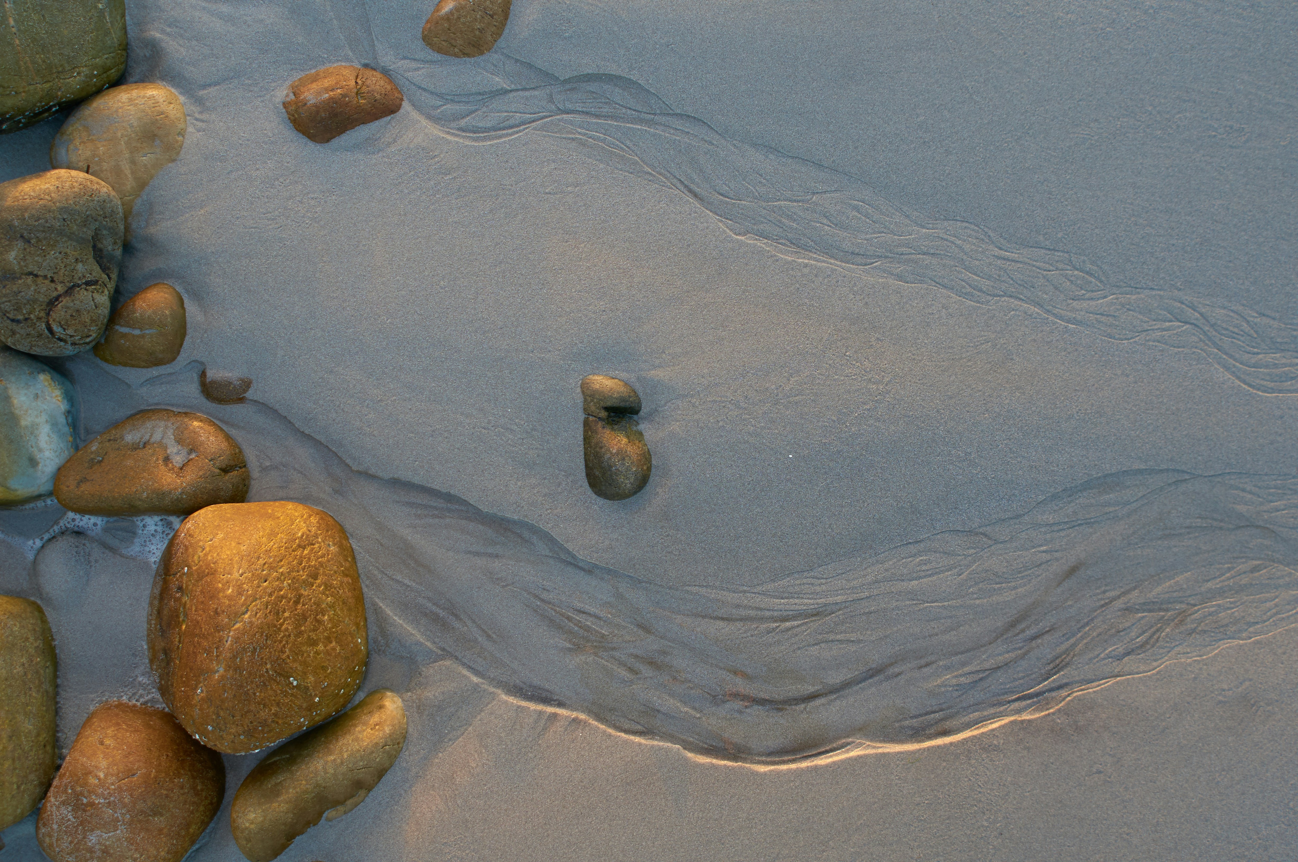 Pebbles on Wet Beach Sand