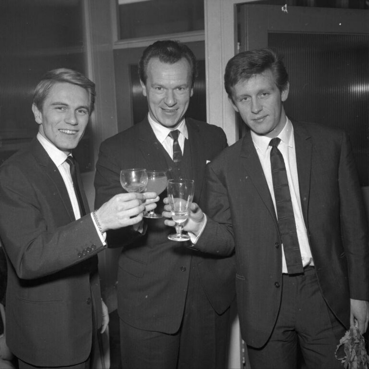 Three Men Toasting With Glasses