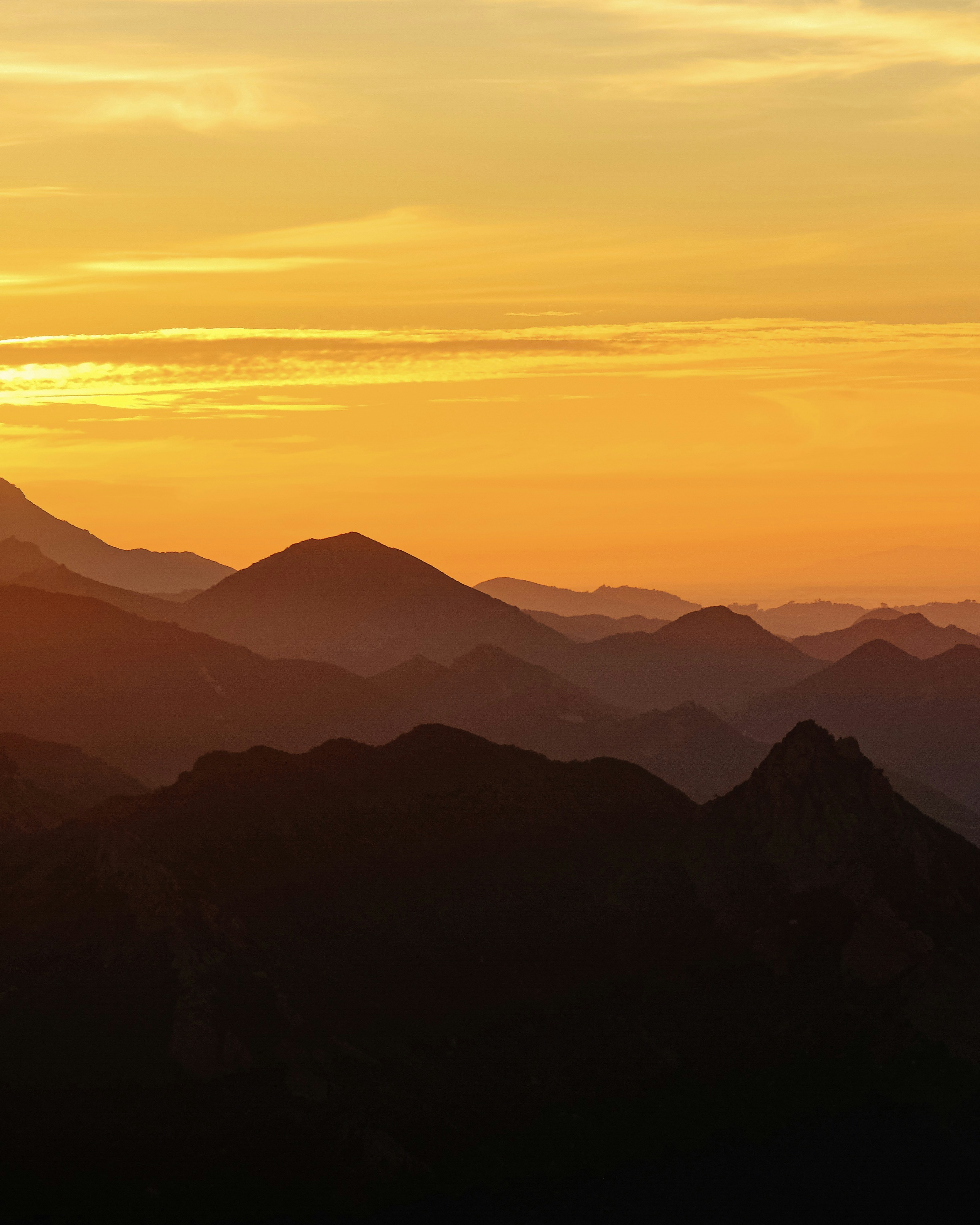 Golden Sunset Over Layered Mountains