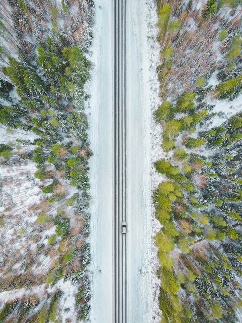 Aerial View of Snowy Forest Road