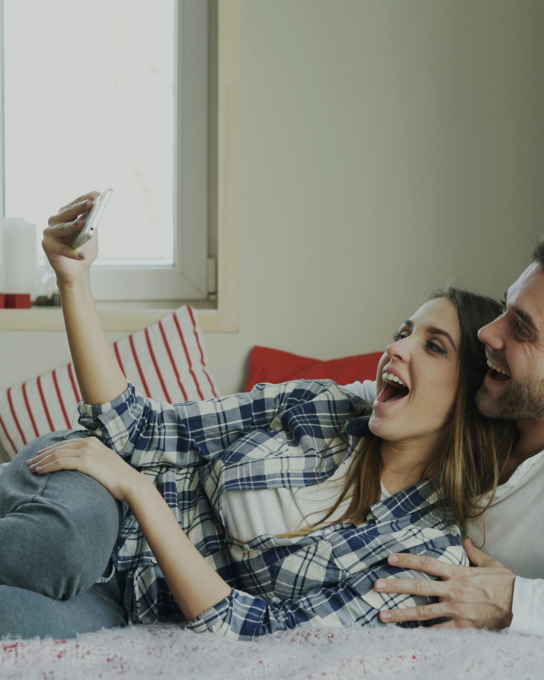 Happy Couple Taking Selfie on Bed