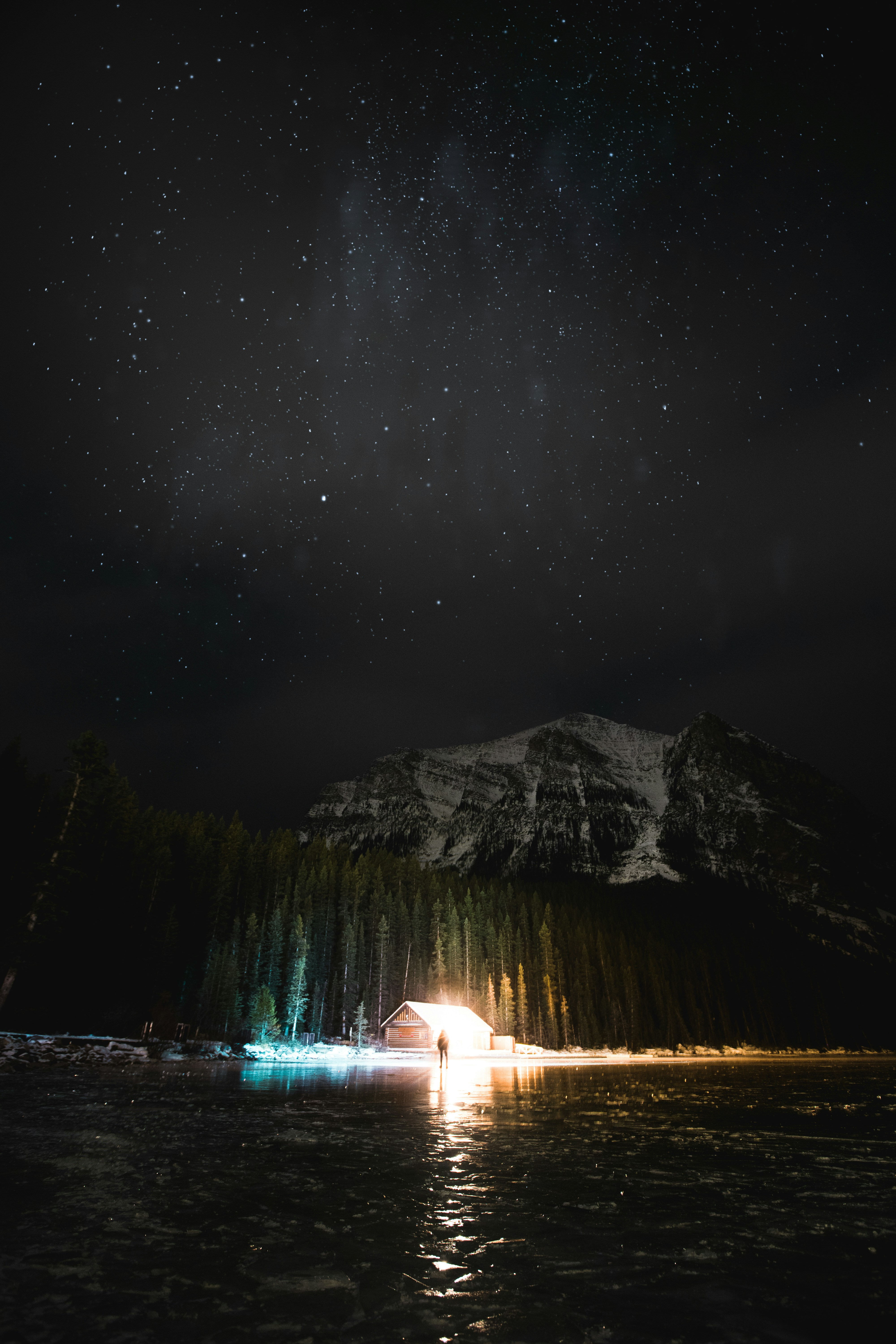 Starry Night Over Frozen Lake Cabin