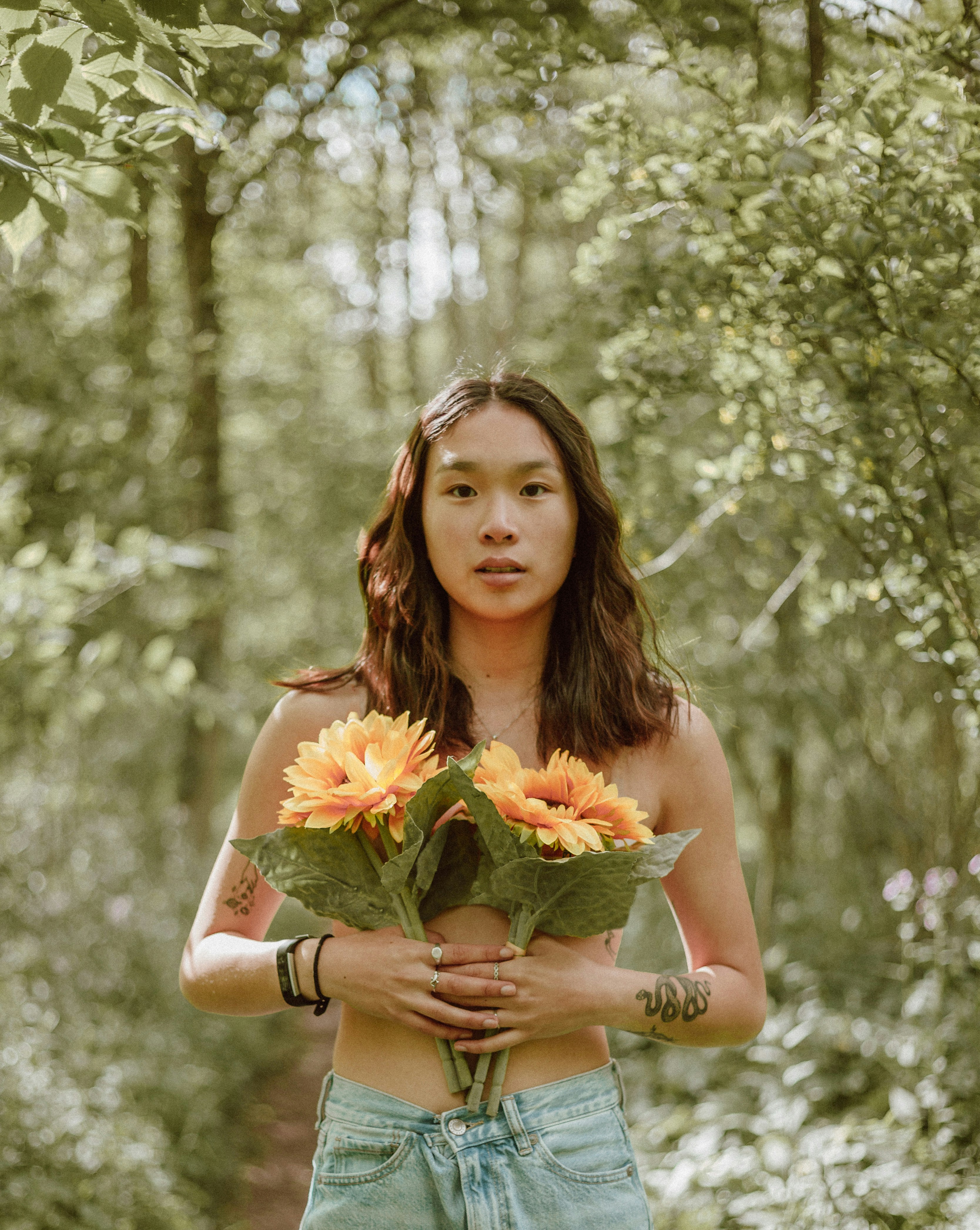 Person Holding Sunflowers In Forest