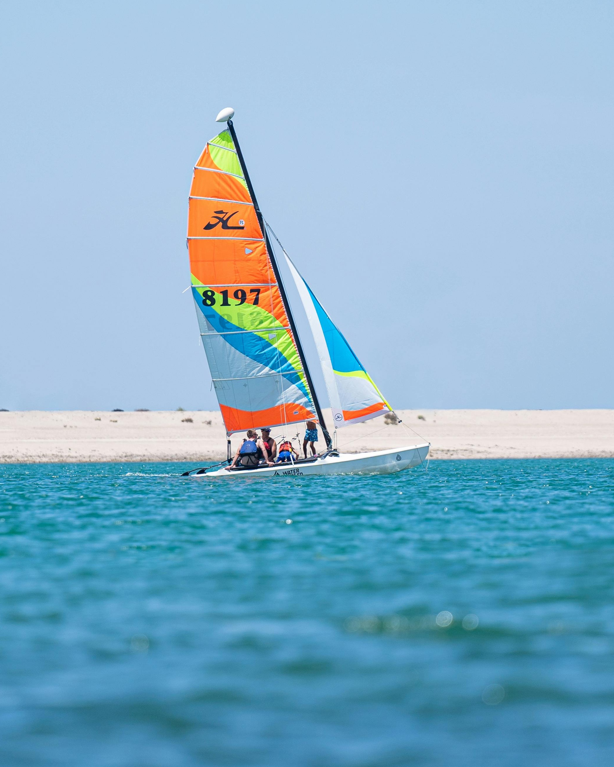 Catamaran Sailboat Near Sandy Shore