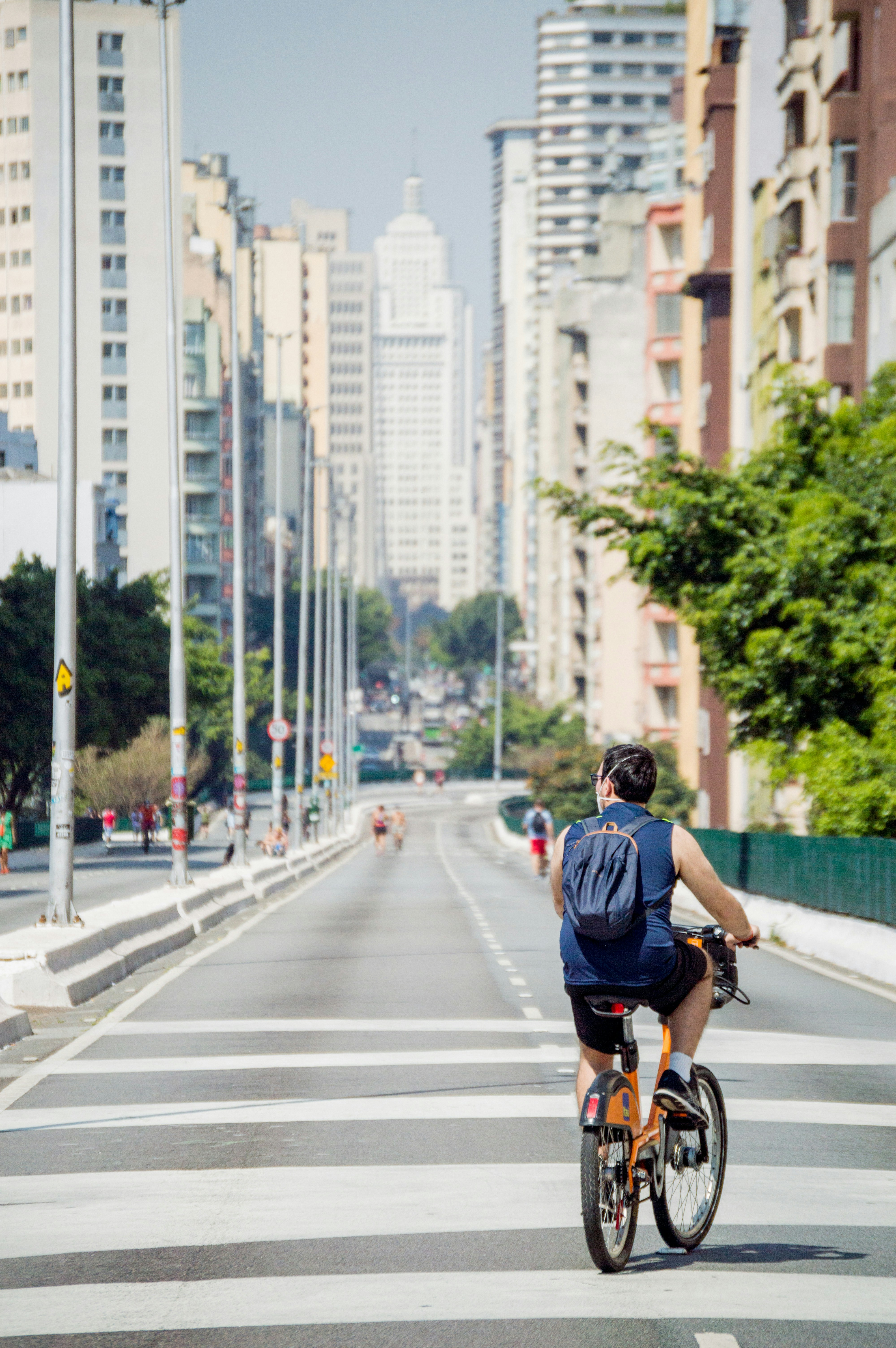 Man Cycling on Downtown City Avenue