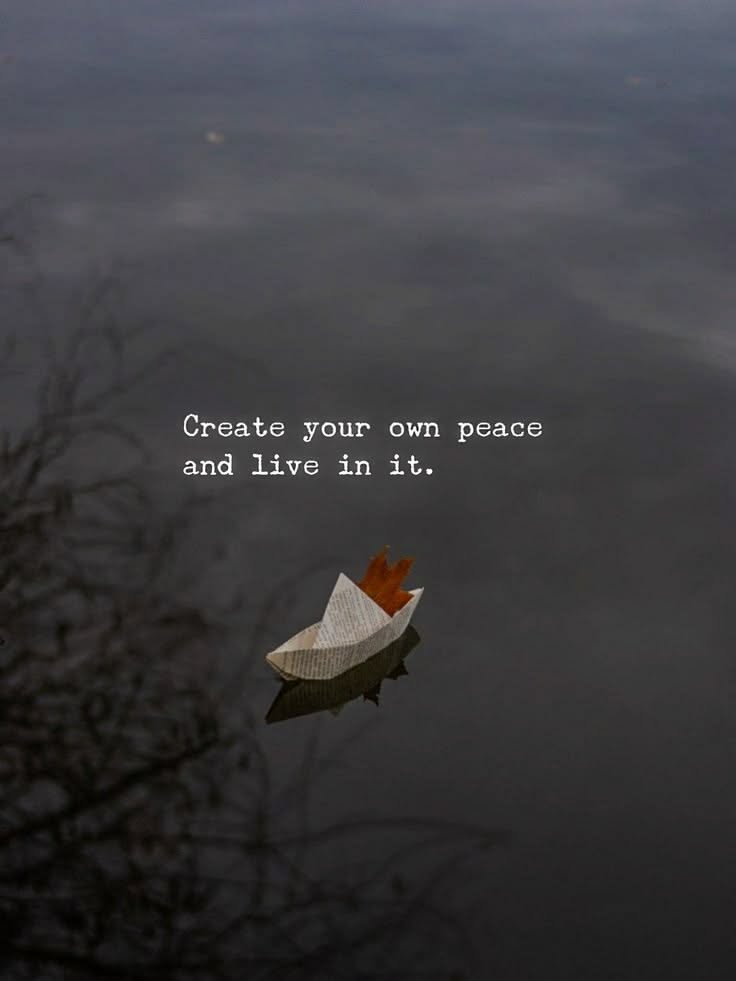 Paper Boat with Peace Quote on Water