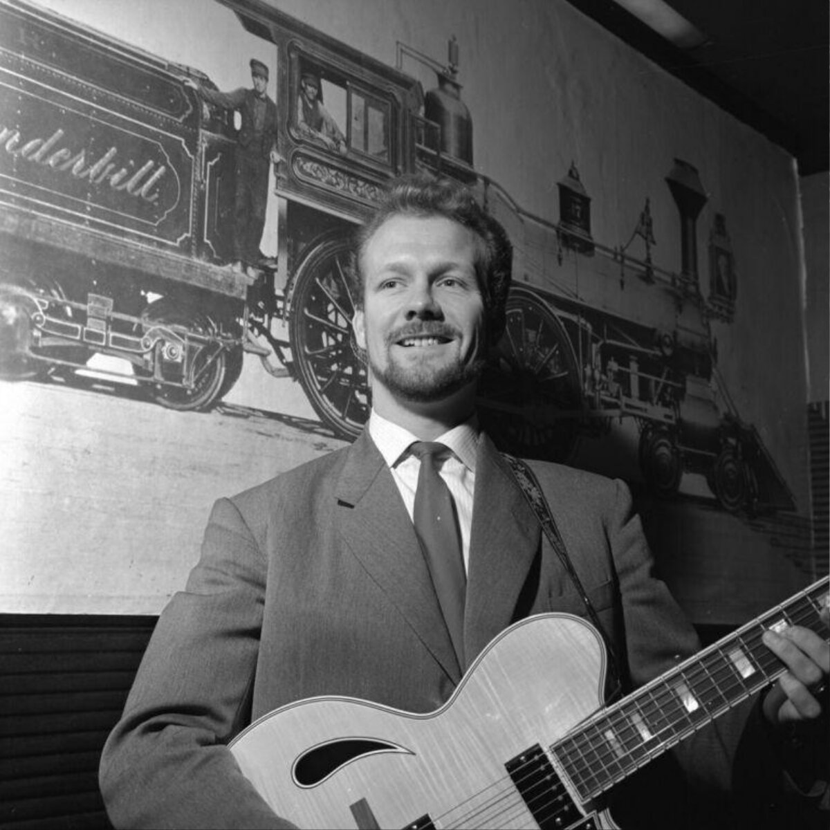 Smiling Guitarist Holding Guitar