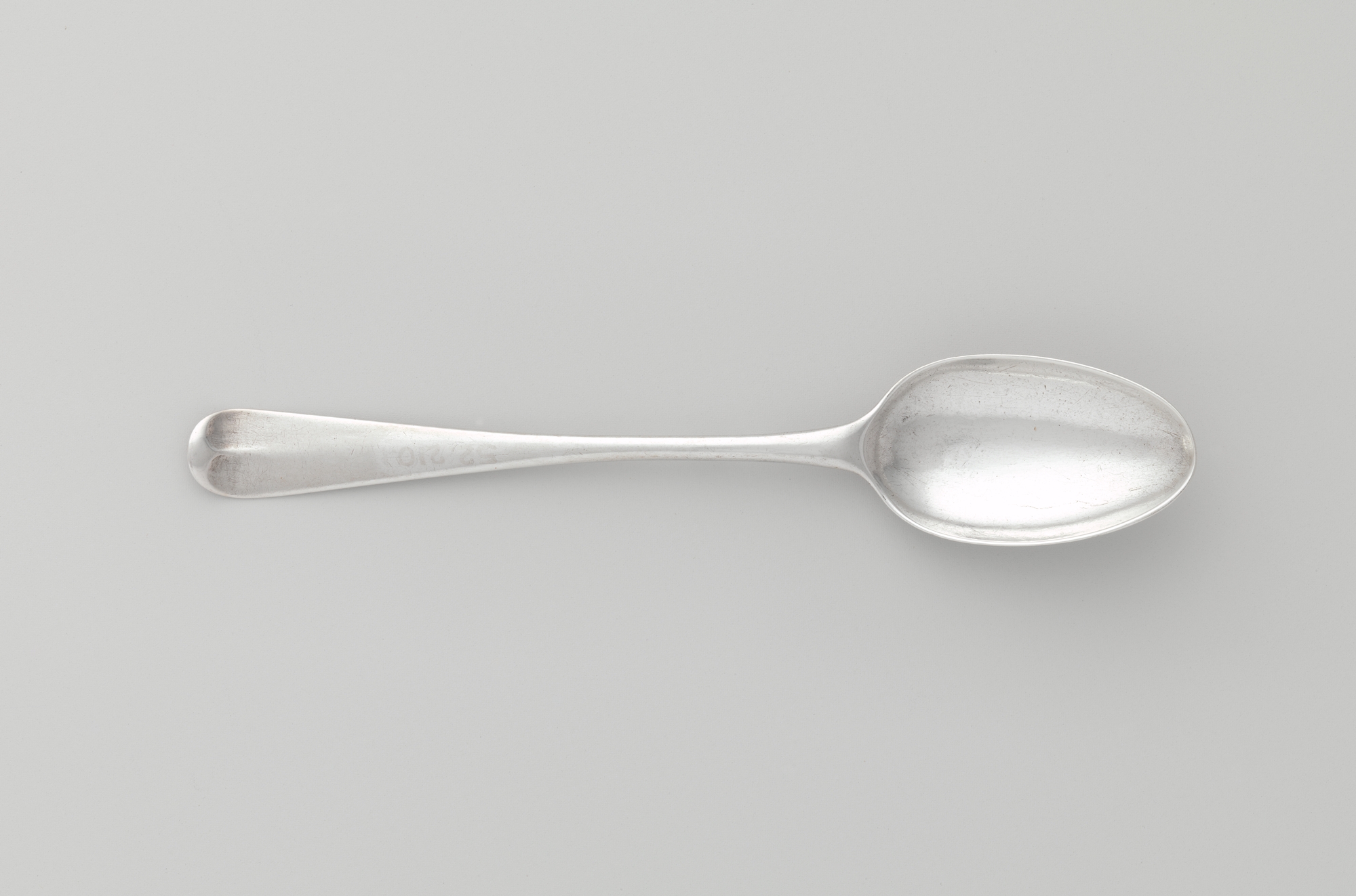 Silver Spoon on Gray Background