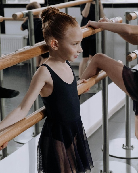 Young Ballerina Practicing at Ballet Barre