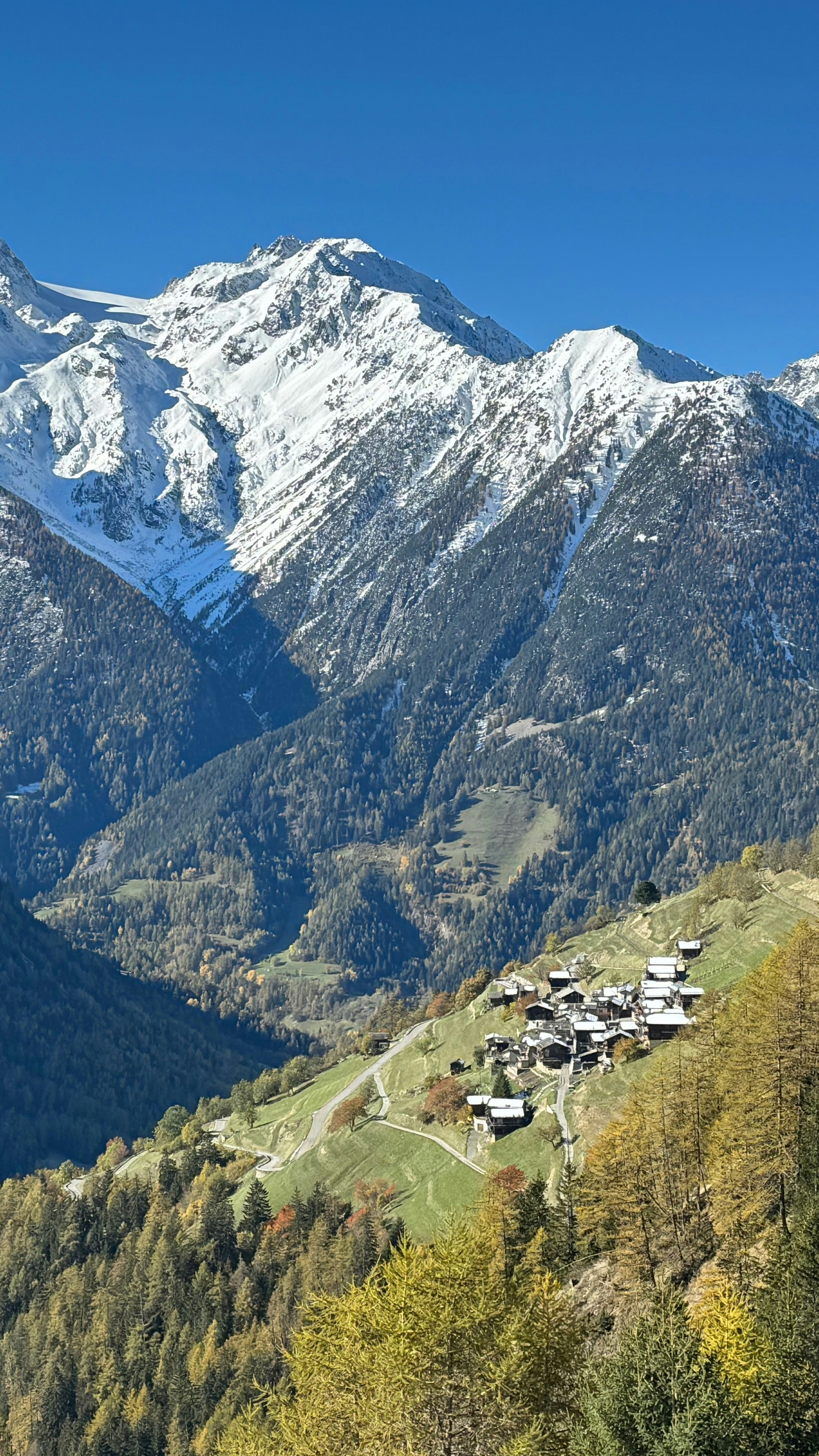 Alpine Village Under Snowy Mountains