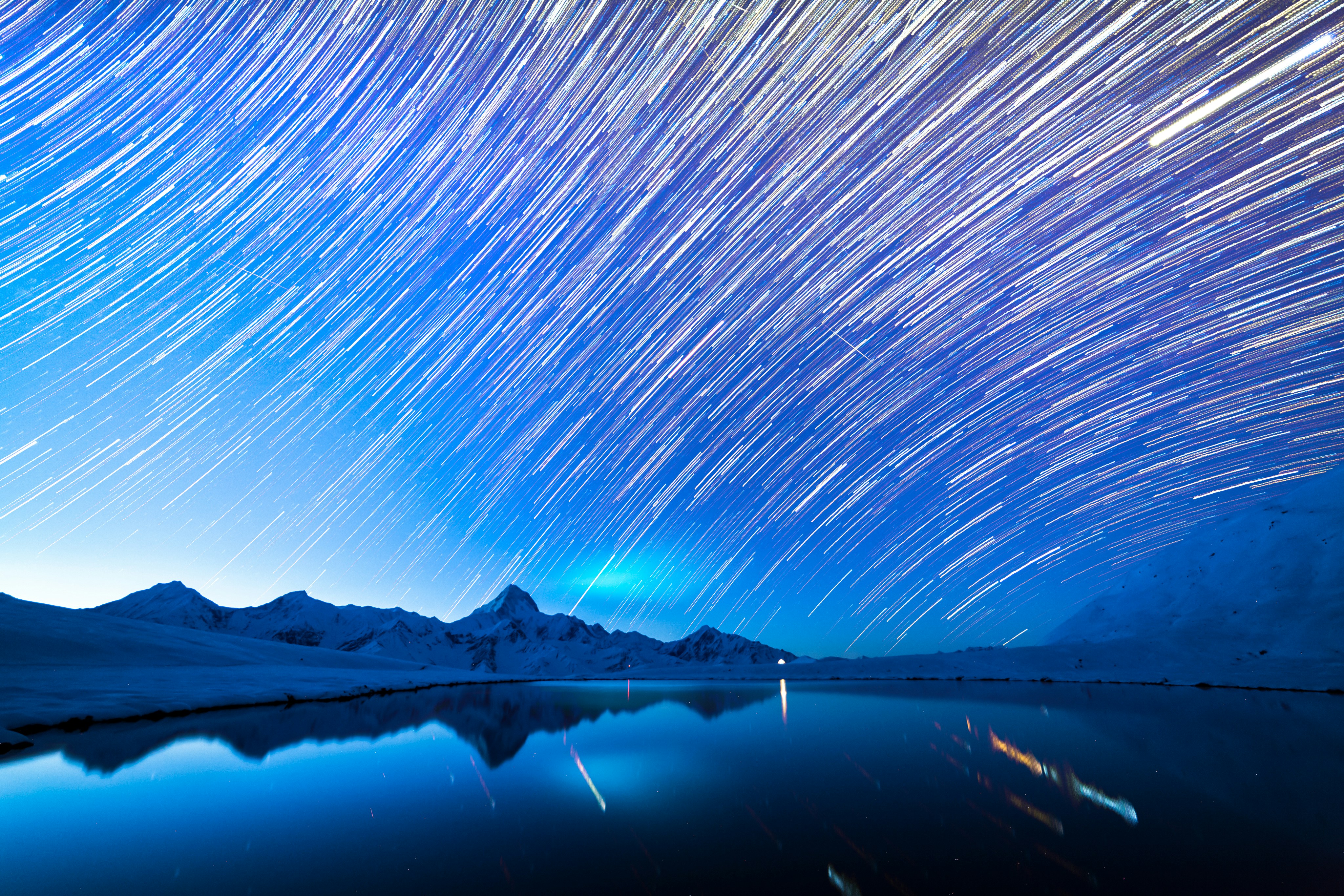 Star Trails Over Snowy Mountain Lake
