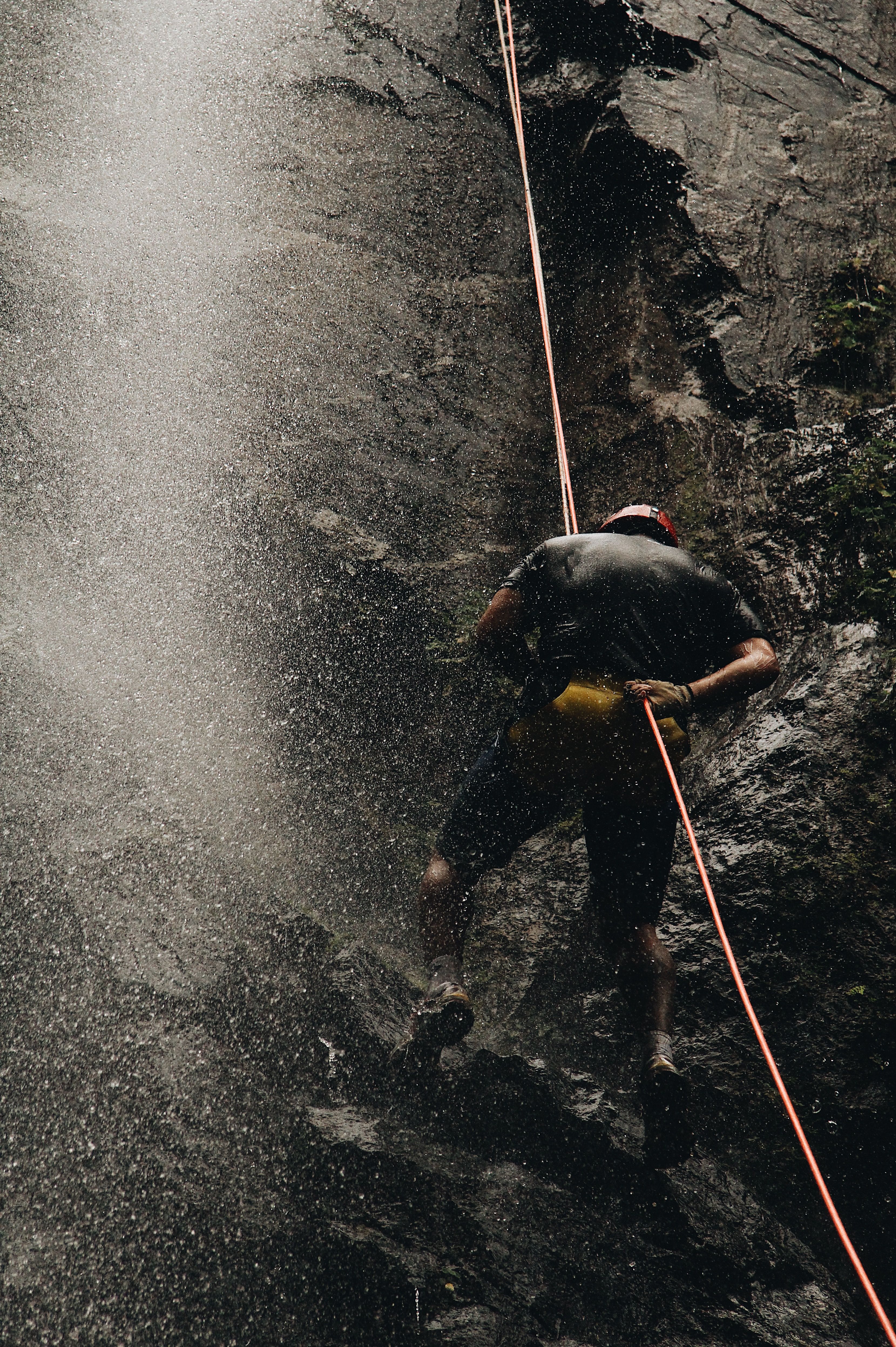 Rappelling Down a Waterfall Cliff