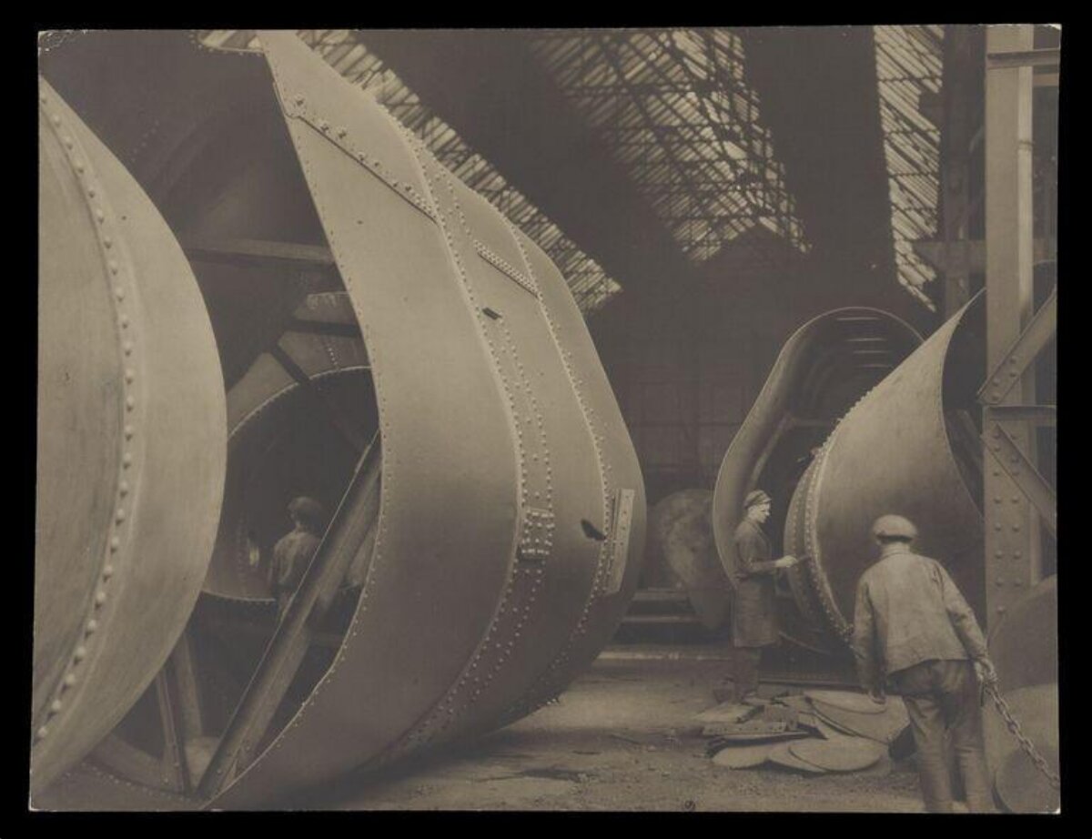 Factory Workers Assembling Large Machine Parts