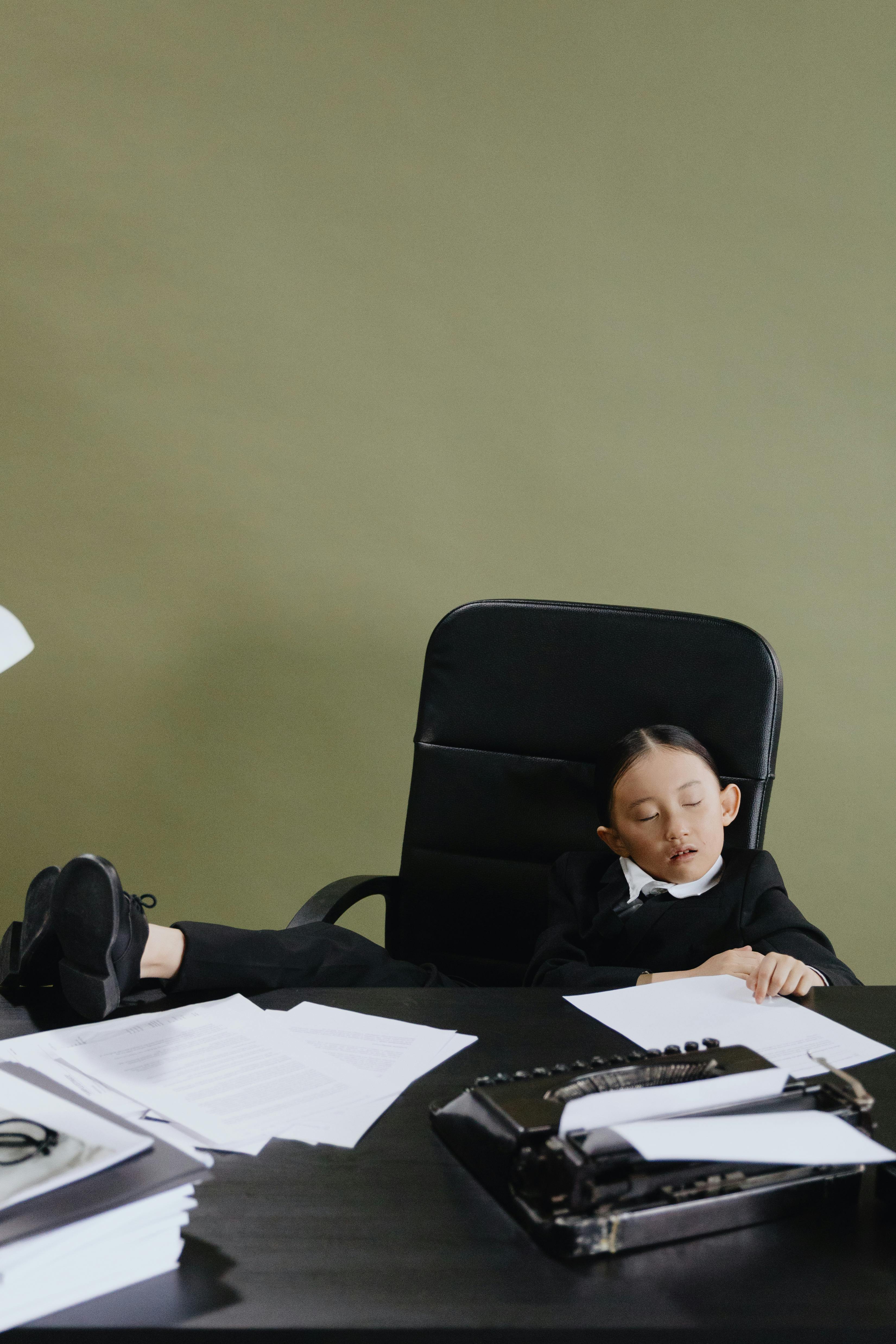 Child Napping At Office Desk