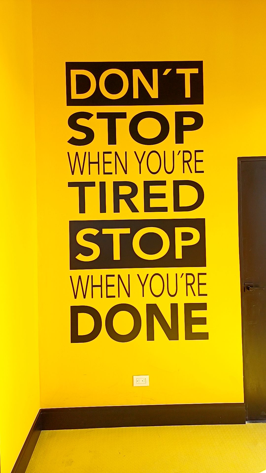 Motivational Quote on Yellow Wall