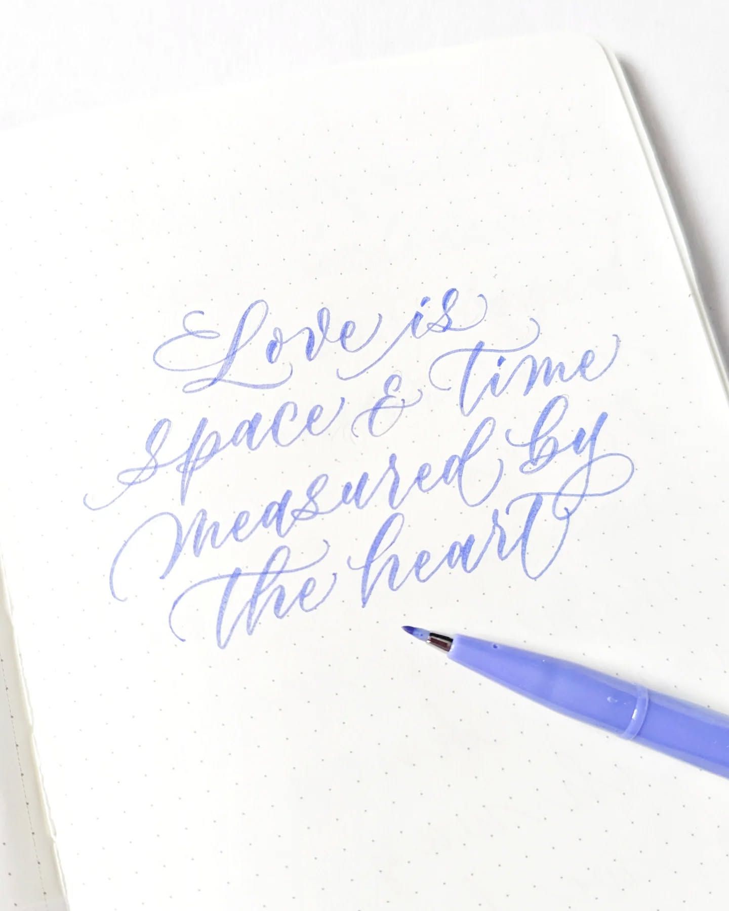 Blue Calligraphy Quote on Dotted Notebook