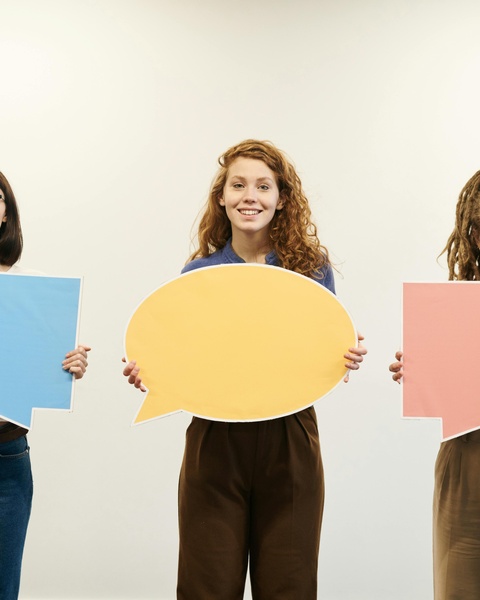 Three People Holding Empty Speech Bubbles
