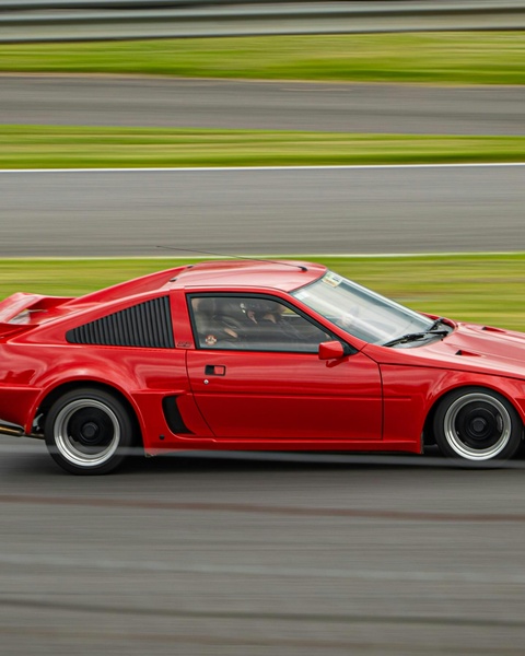 Red Sports Car on Race Track