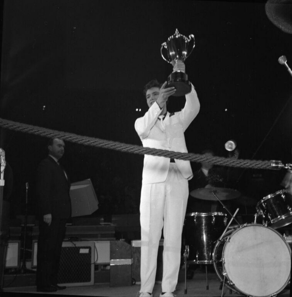 Man Lifting Trophy on Performance Stage