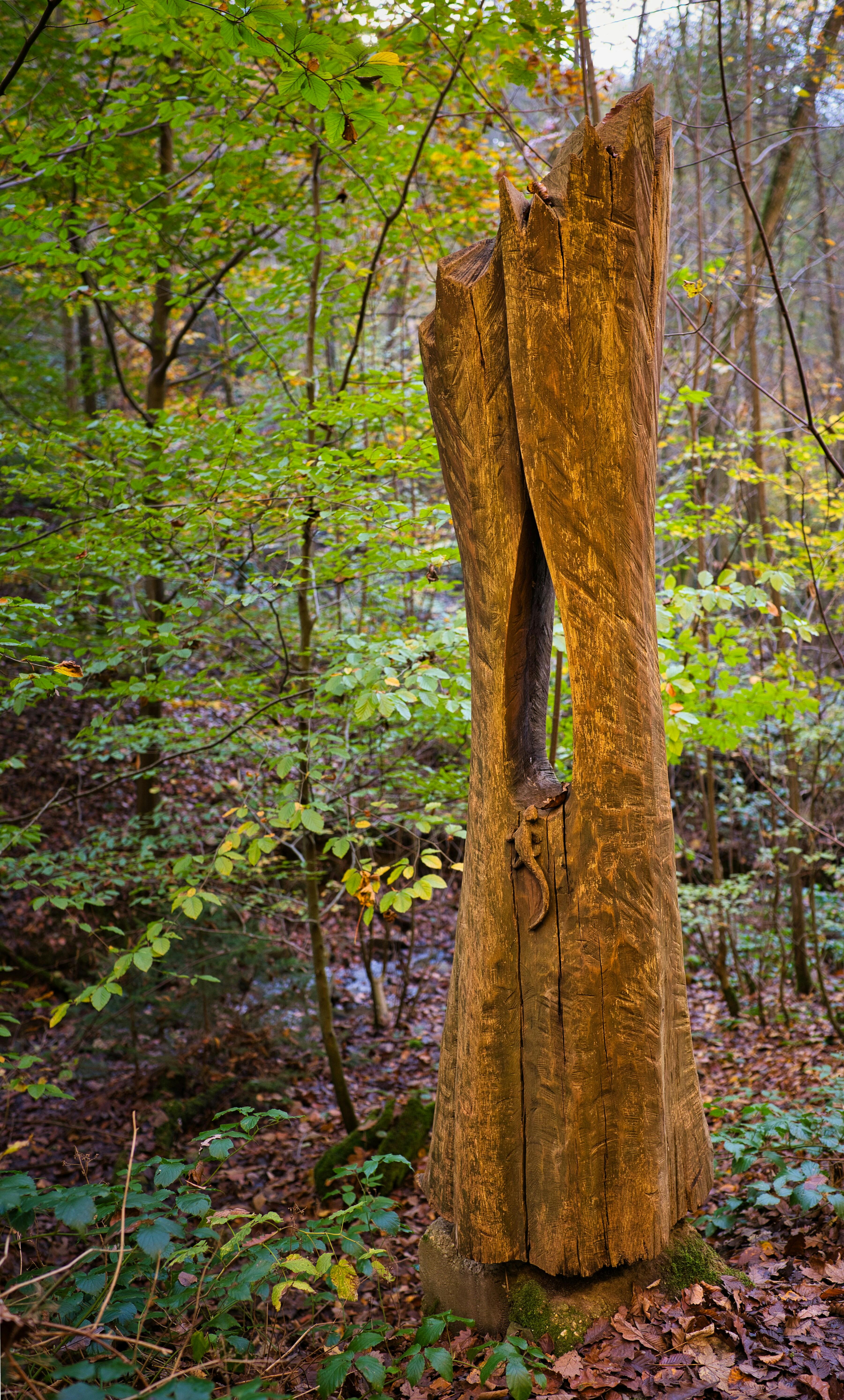 Carved Tree Trunk Sculpture in Autumn Forest