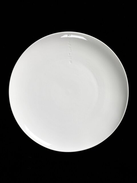 White Round Plate on Black Background
