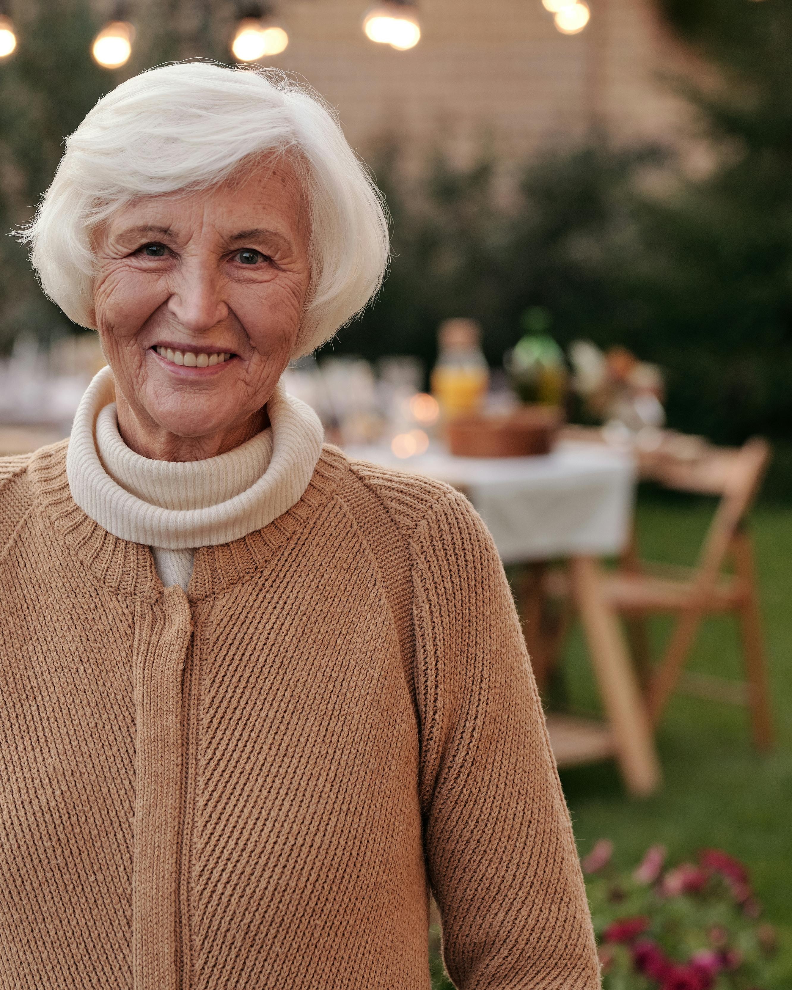 Smiling Senior Woman at Backyard Gathering