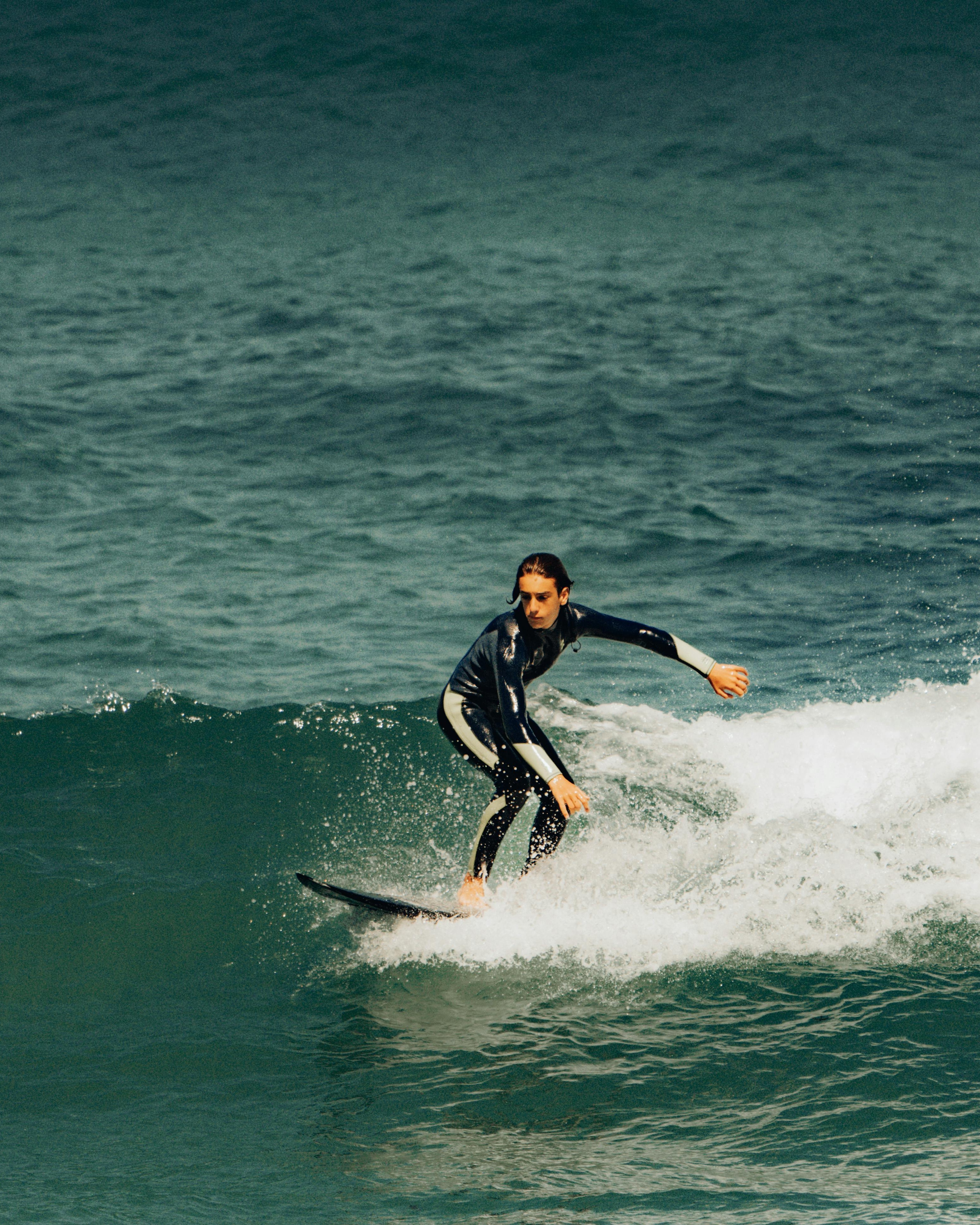Surfer Riding a Coastal Wave