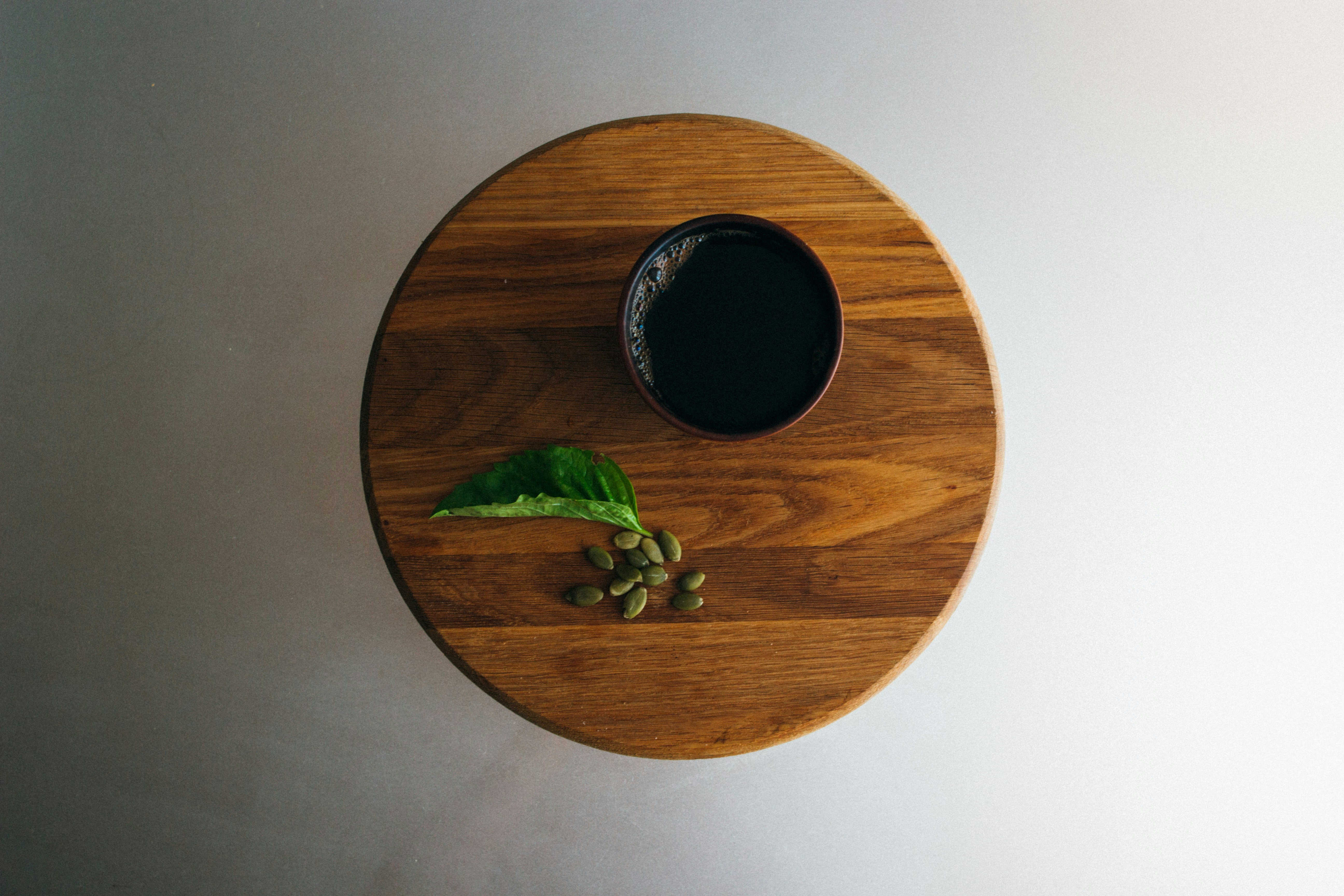 Black Coffee on Round Wooden Board
