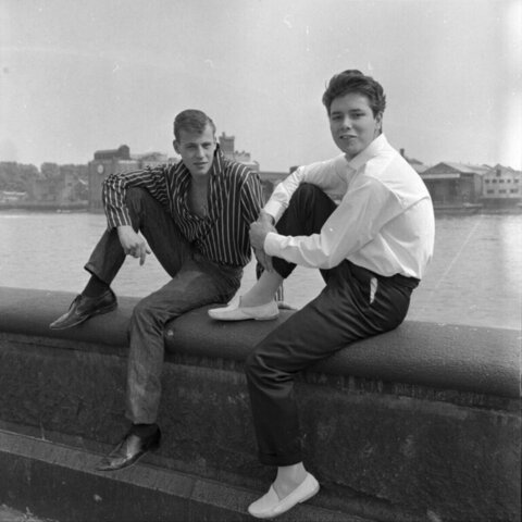 Two Young Men Sitting By The River
