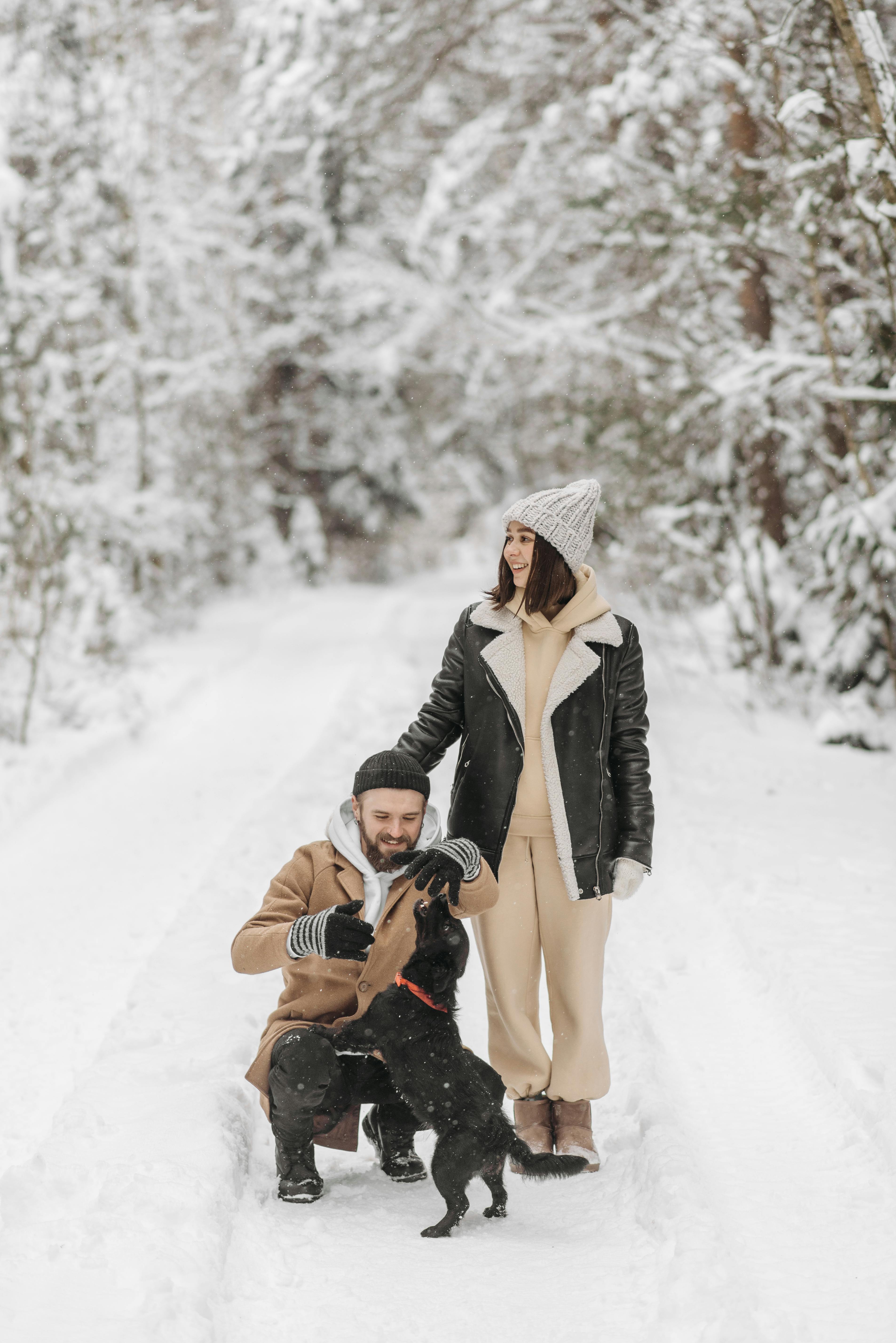 Couple and Dog on Winter Forest Path