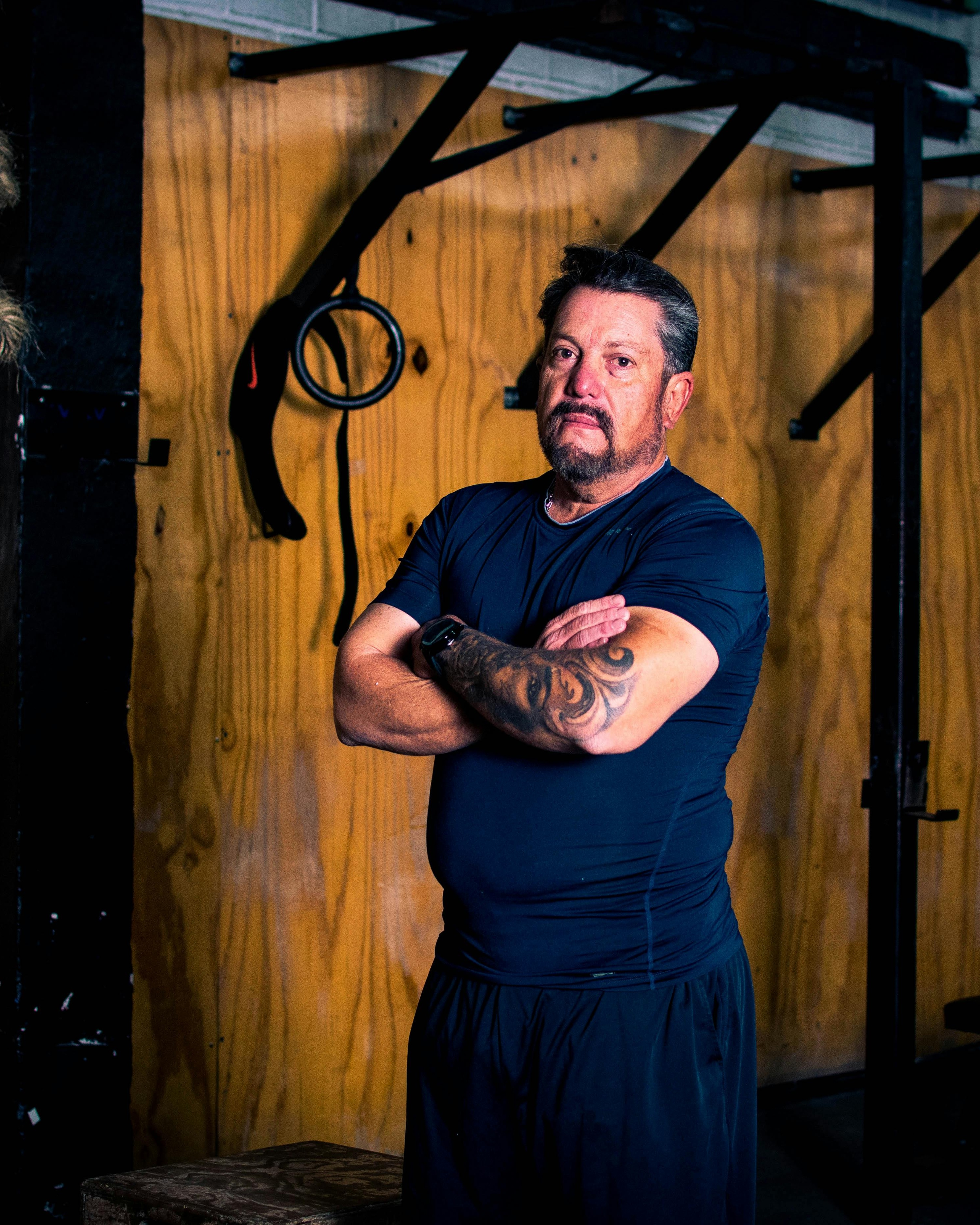 Middle Aged Gym Trainer With Crossed Arms