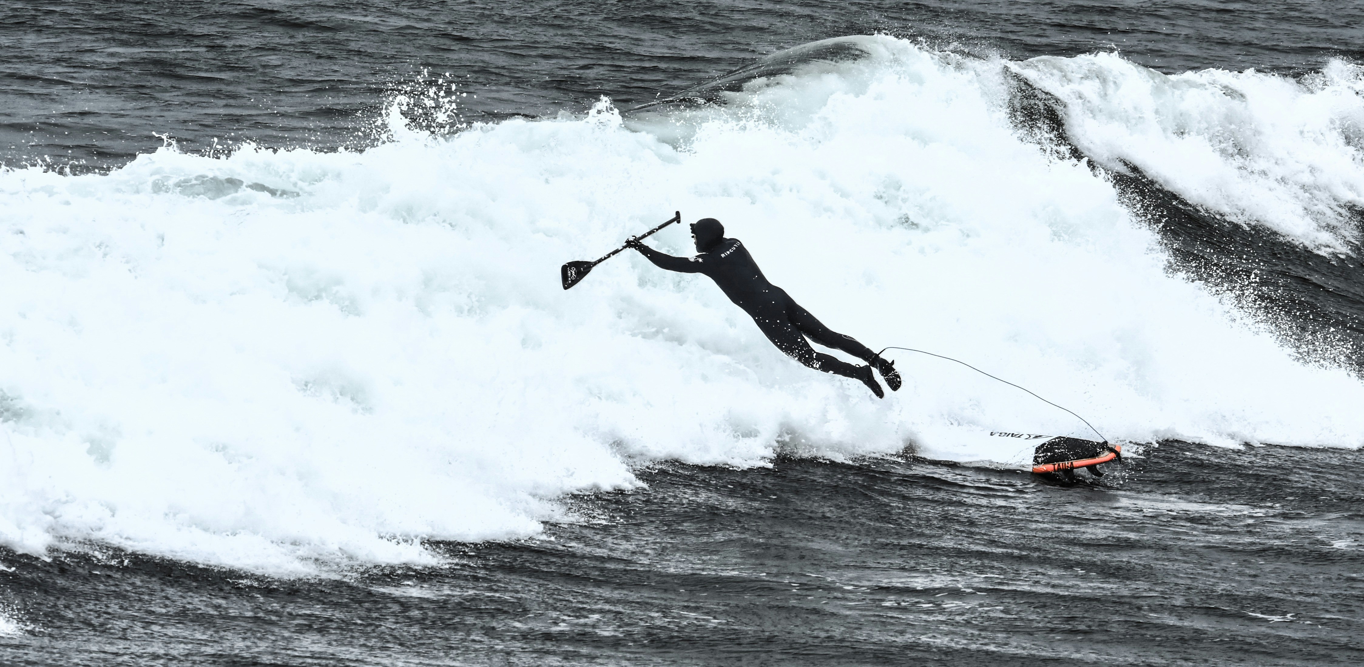 Paddle Surfer Falling Into Ocean Wave